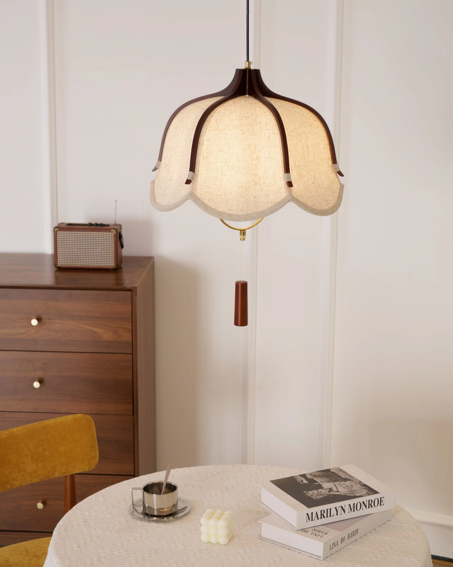 Evelyn scalloped pendant light in minimalist interior with yellow accent chair and round table