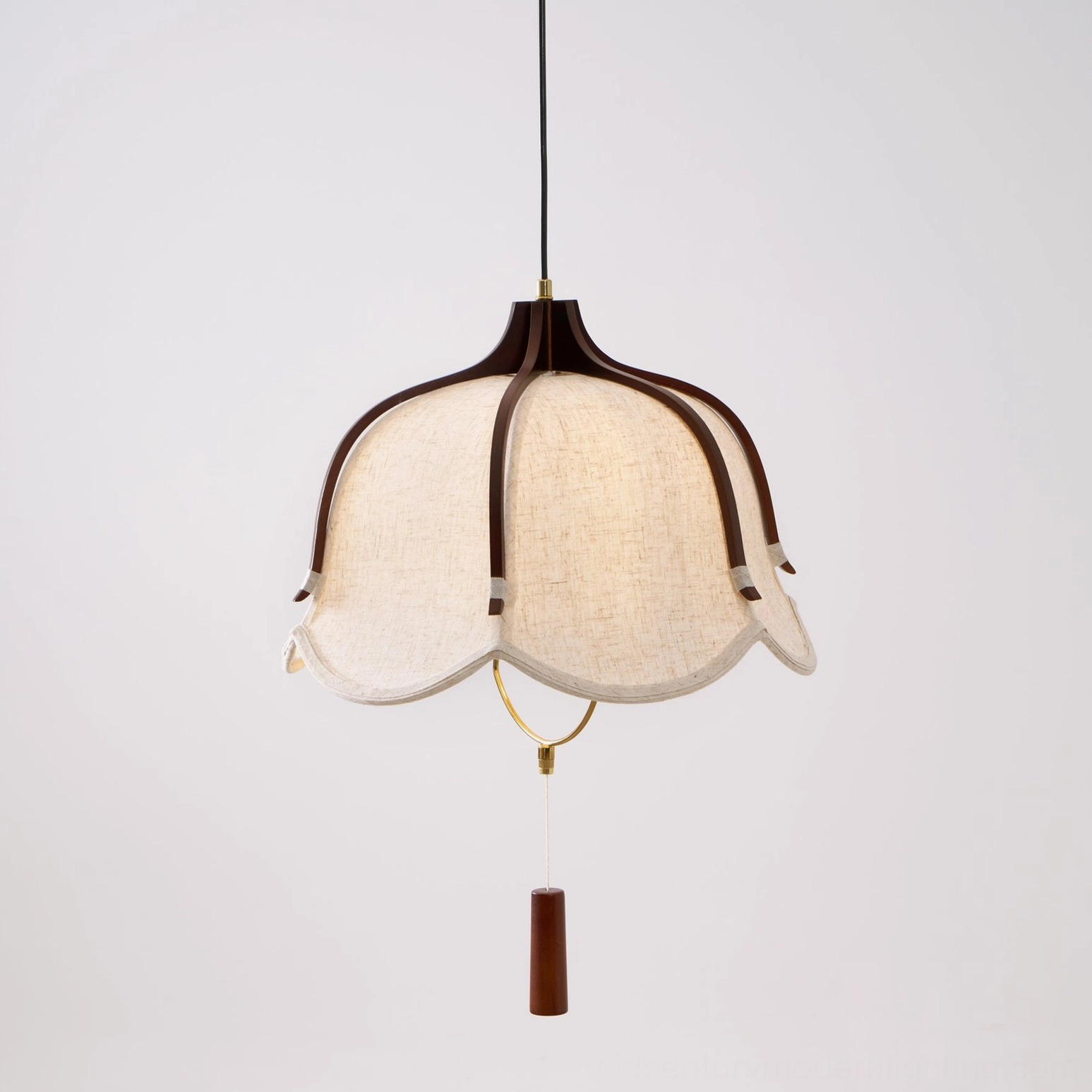 Extreme close-up of Evelyn pendant lamp linen fabric shade with scalloped edges and dark wood frame