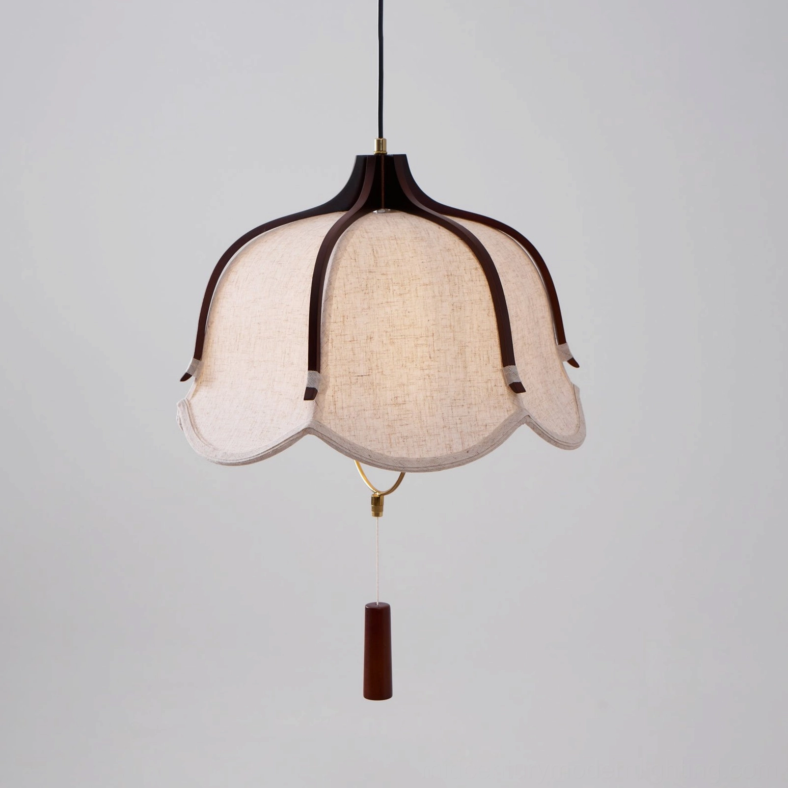Evelyn pendant lamp with walnut wood frame, hand demonstrating vintage pull switch detail