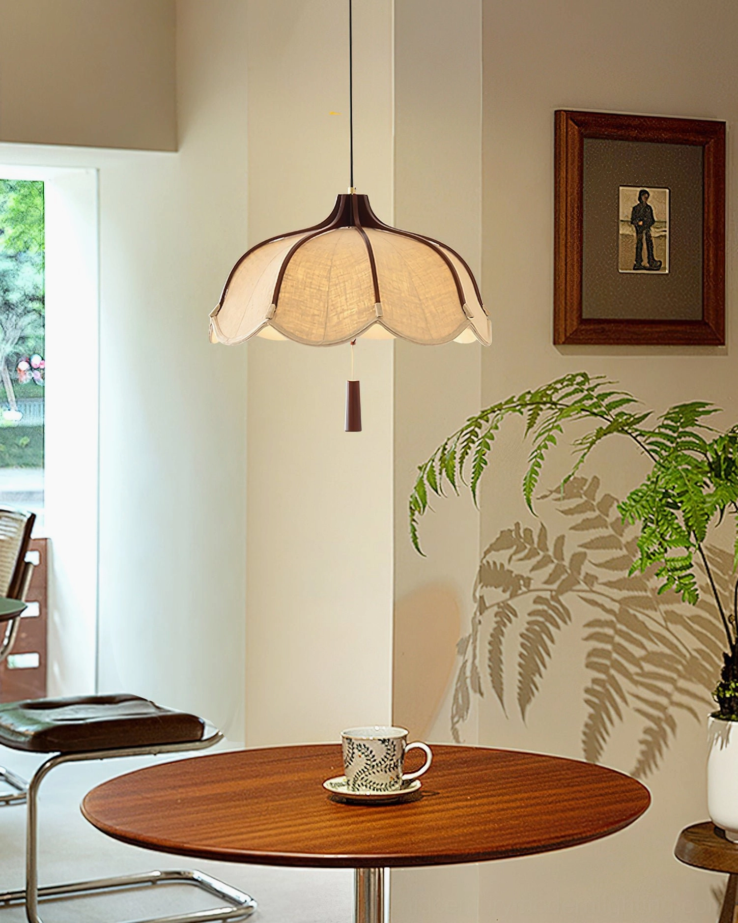 Evelyn mid-century pendant lamp in corner interior with leather armchair and sheer curtains, warm ambient glow