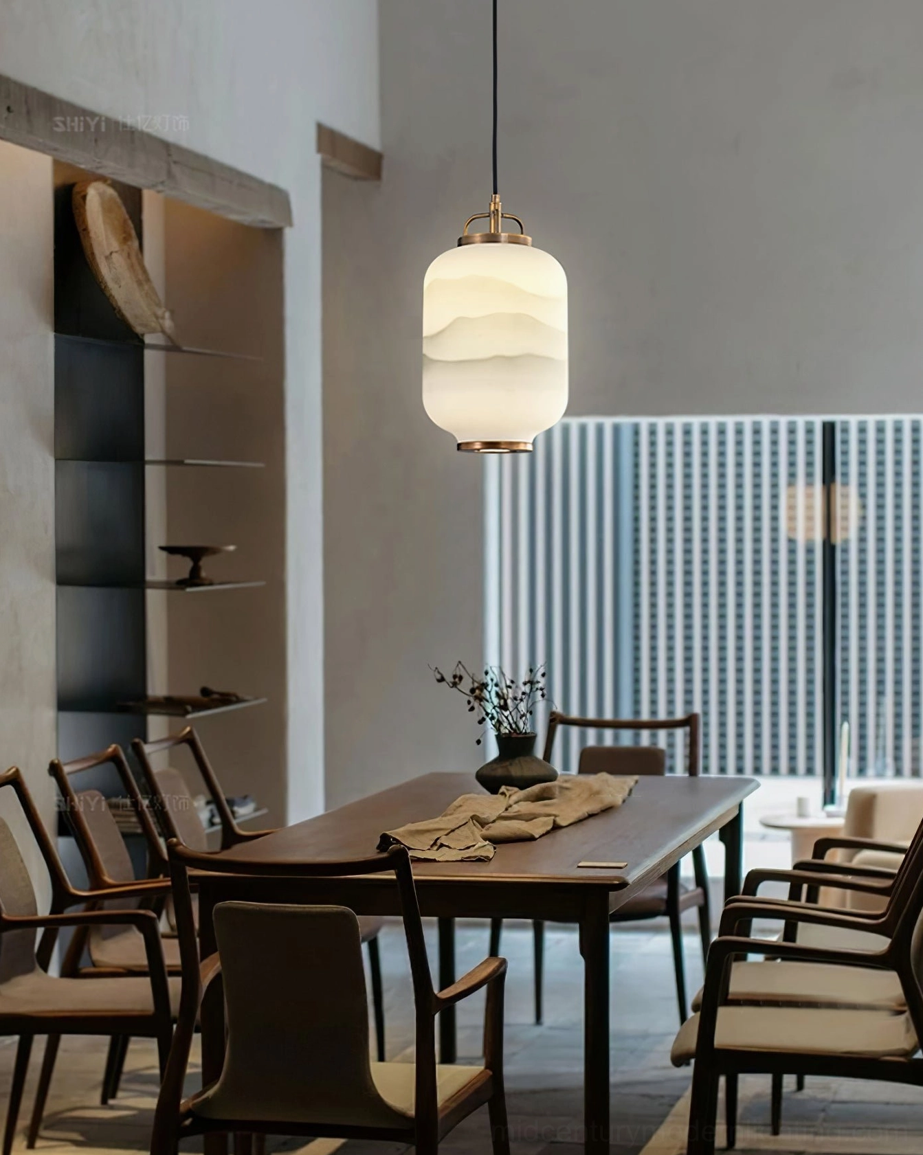 Ezio Pendant Lamp in dining room with frosted glass shade and brass hardware