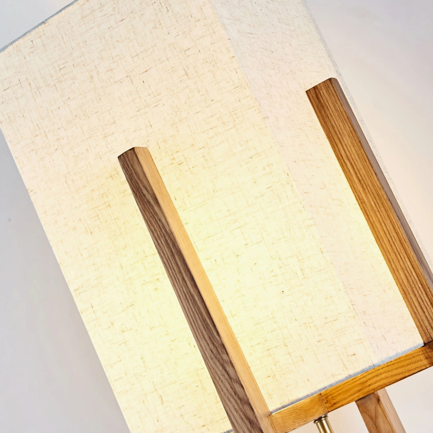 Fairbanks table lamp warm glowing linen shade visible wood texture illuminated