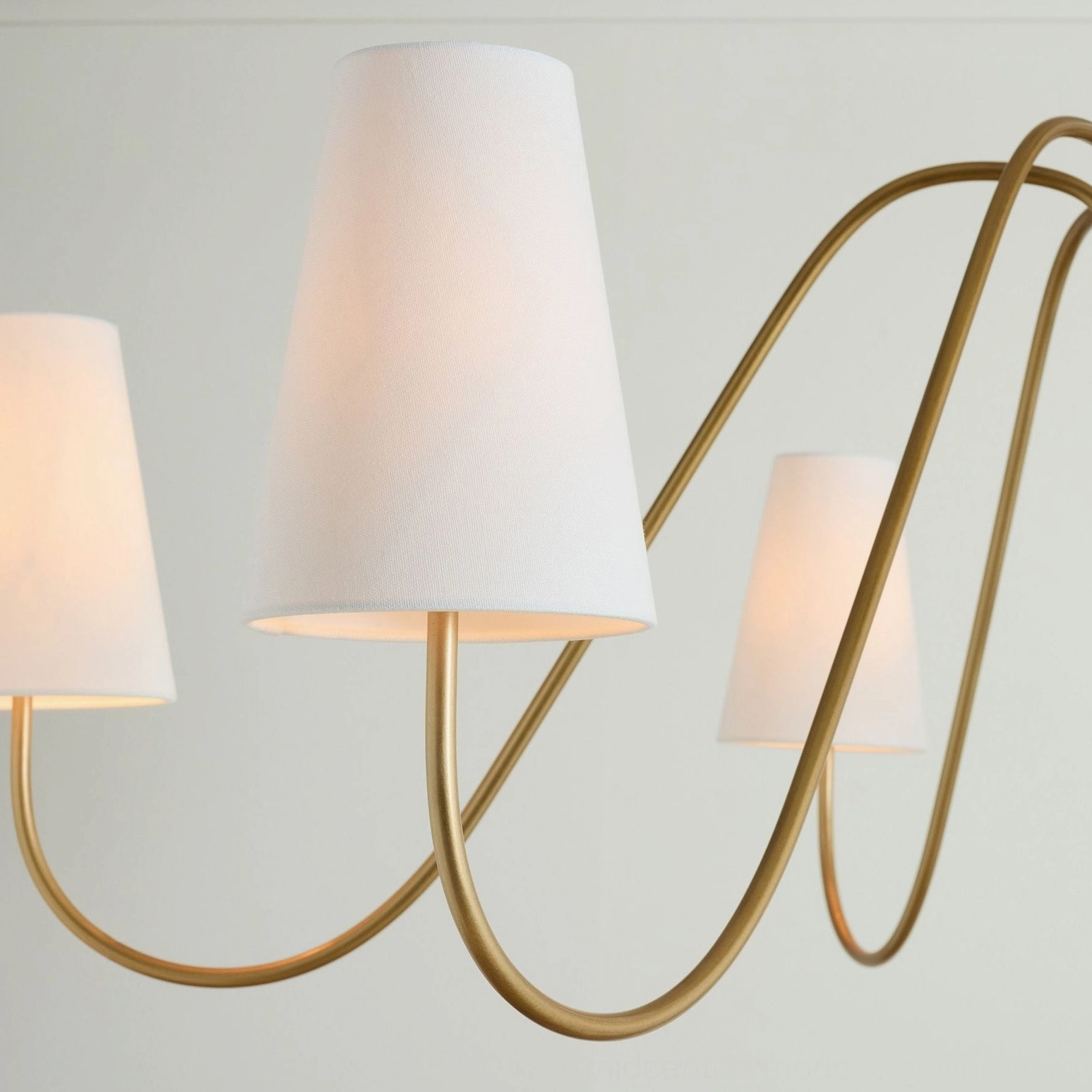 Close-up macro detail of Farlane chandelier brass metalwork and conical fabric shade construction