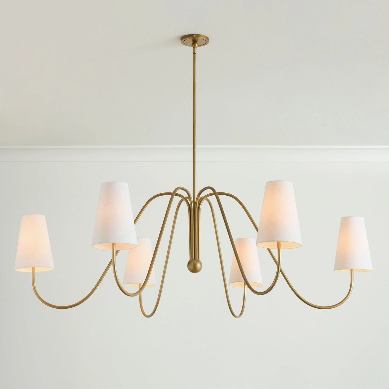 Curved brass arms of Farlane chandelier showing sculptural metalwork and tapered fabric shade detail