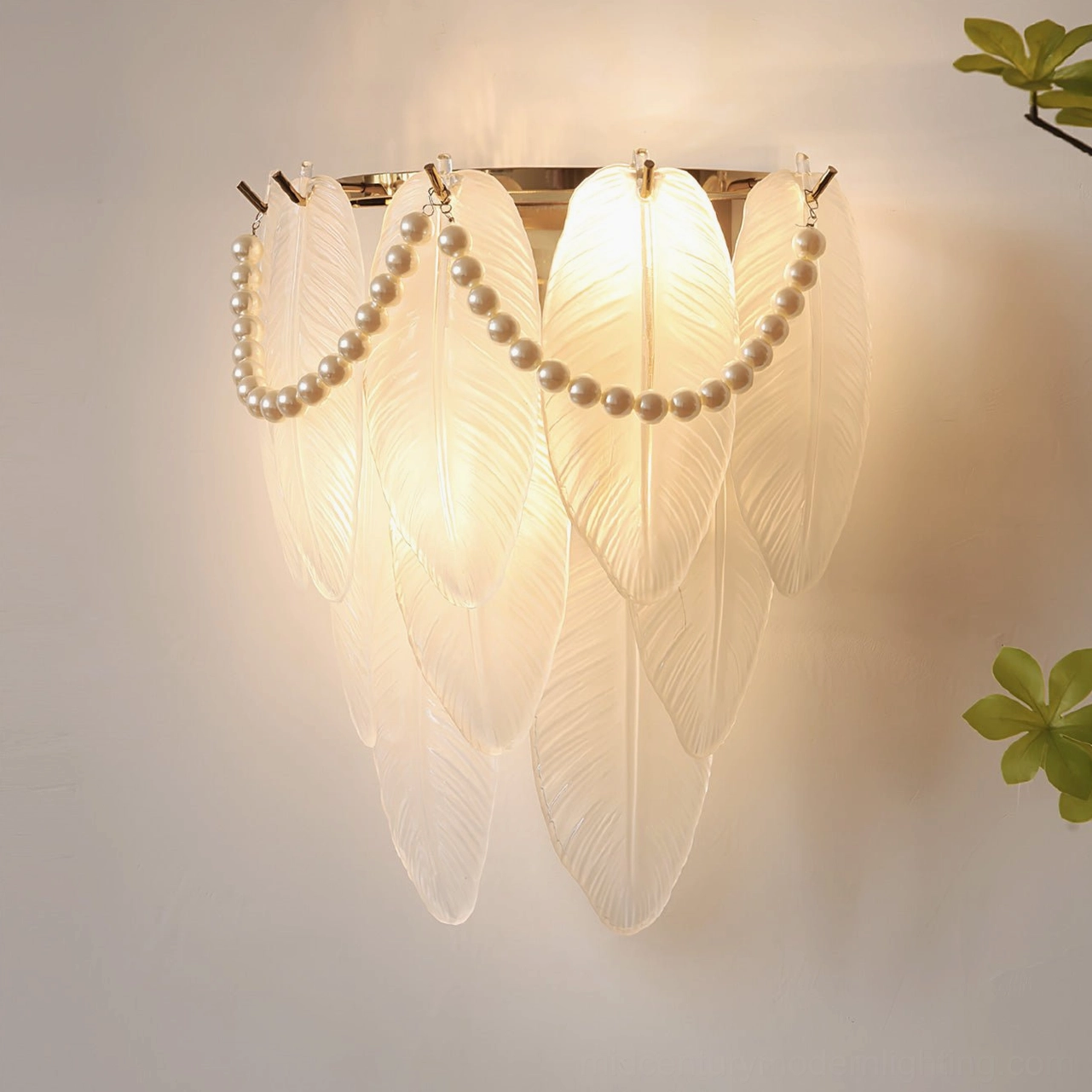 Feather Pearl Wall Sconce - illuminated warm glow, layered feather shades with pearl chain accents, indoor living room display