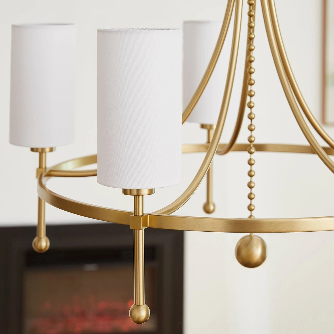 Close-up of Fenwick brass chandelier gold metal arms and spherical hanging ornaments