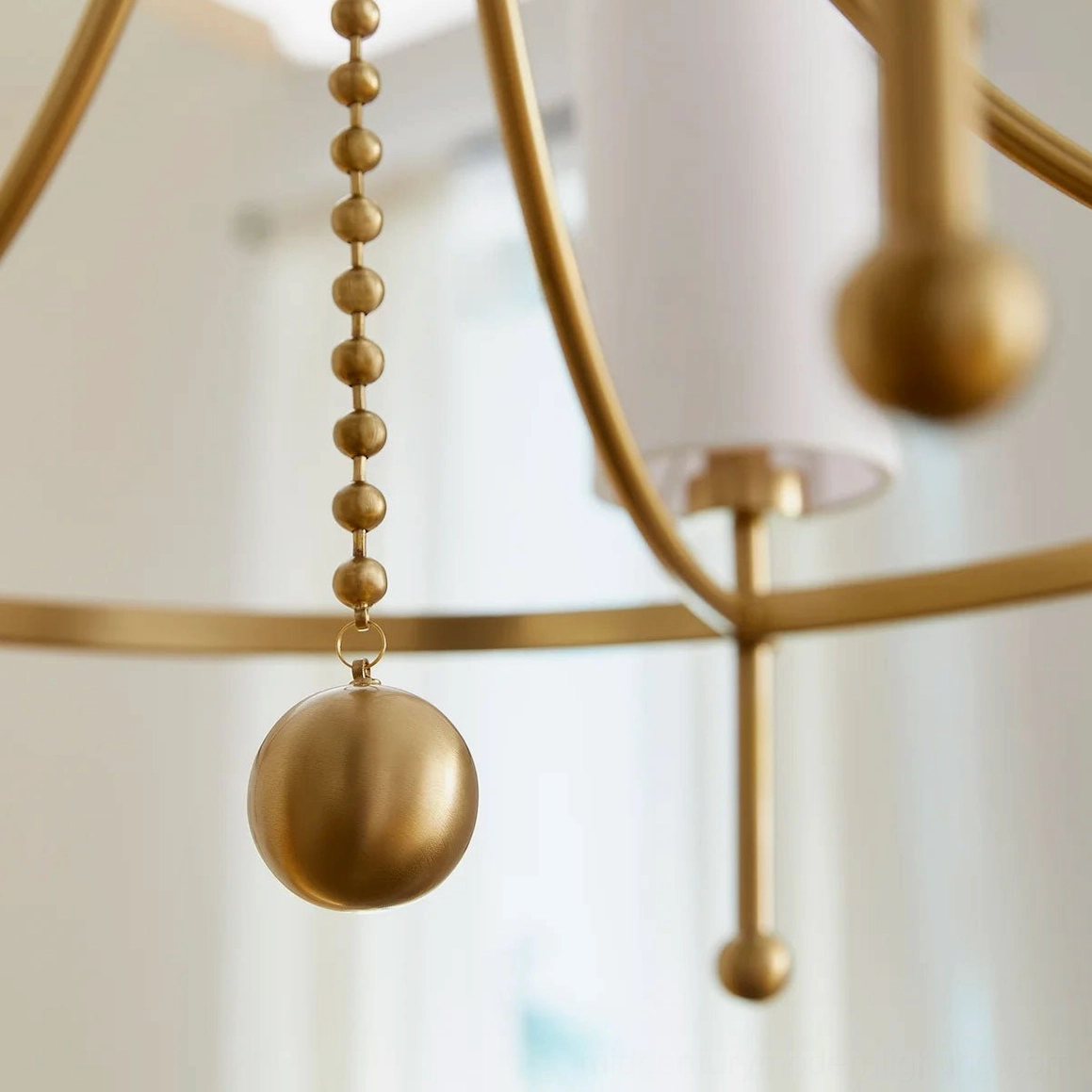 Fenwick brass chandelier spherical hanging pendant ornament, side close-up view
