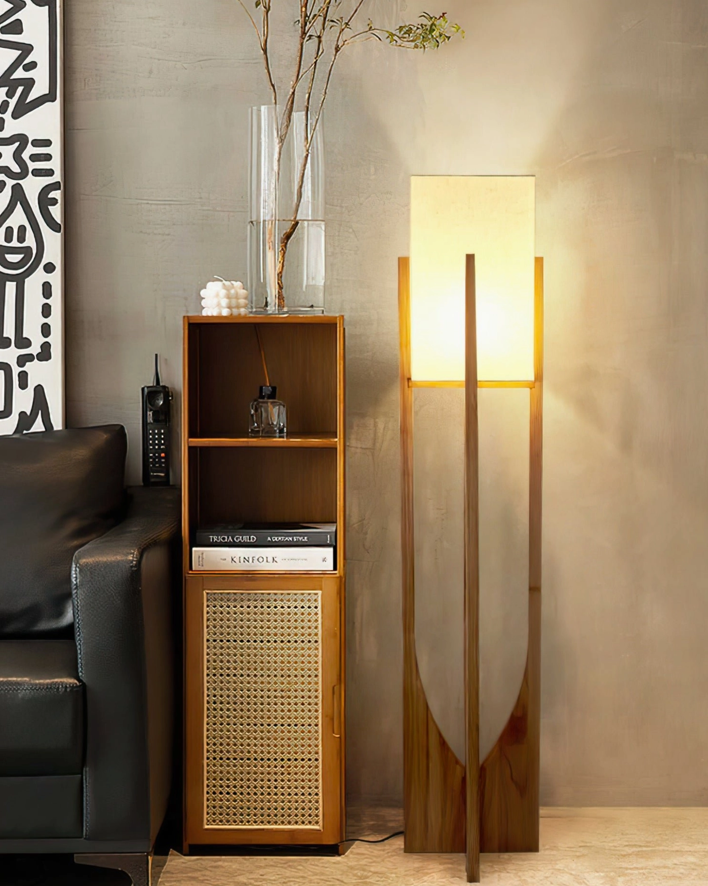 Contemporary floor lamp beside leather sofa and rattan furniture providing evening ambient light