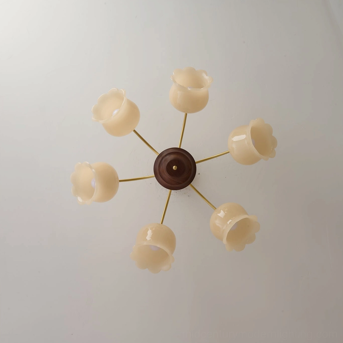 Unassembled flower chandelier frame showing brass arms, walnut wood base, and empty shade sockets, component overview