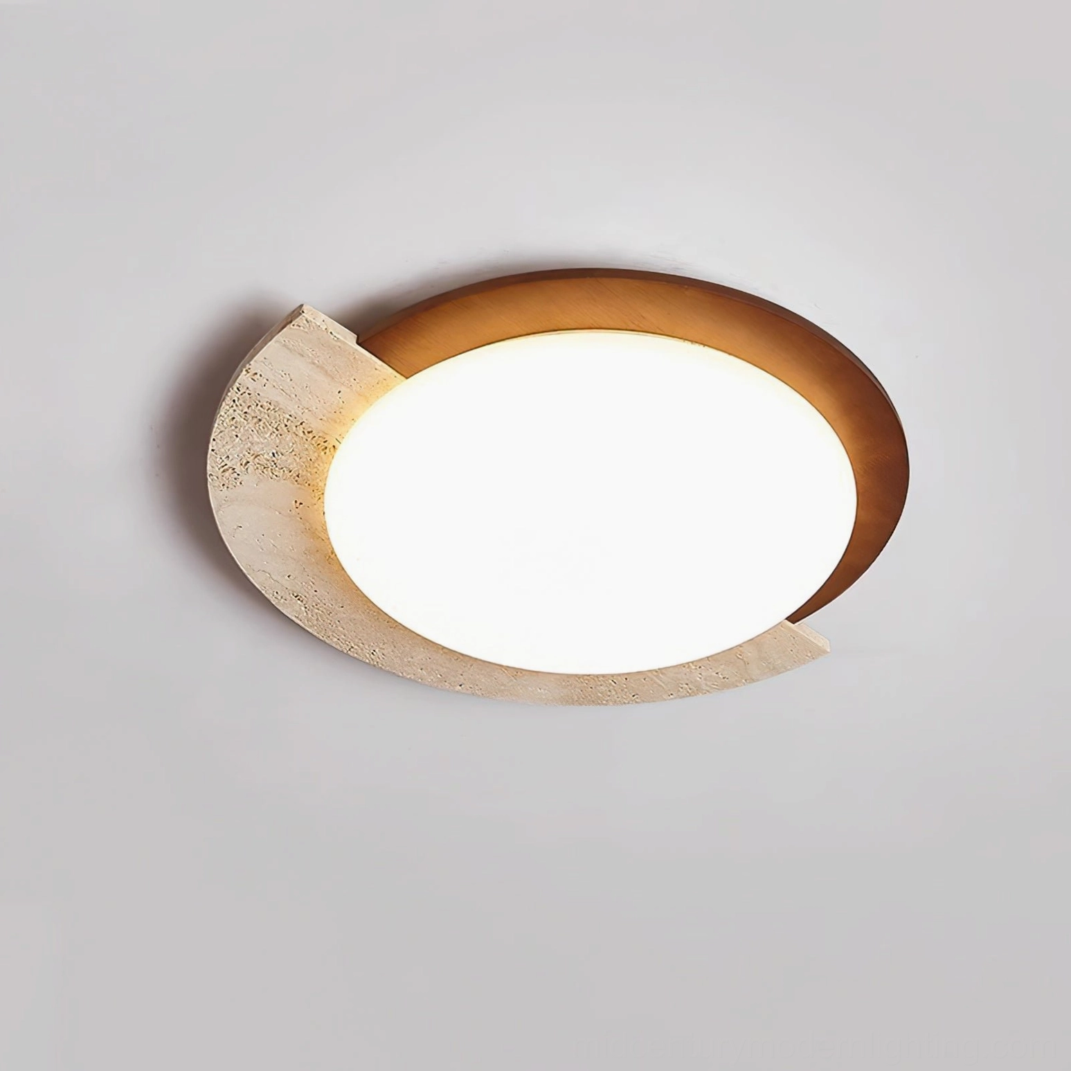 Side overhead detail view of asymmetrical flush ceiling lamp highlighting travertine stone texture and warm wood tone