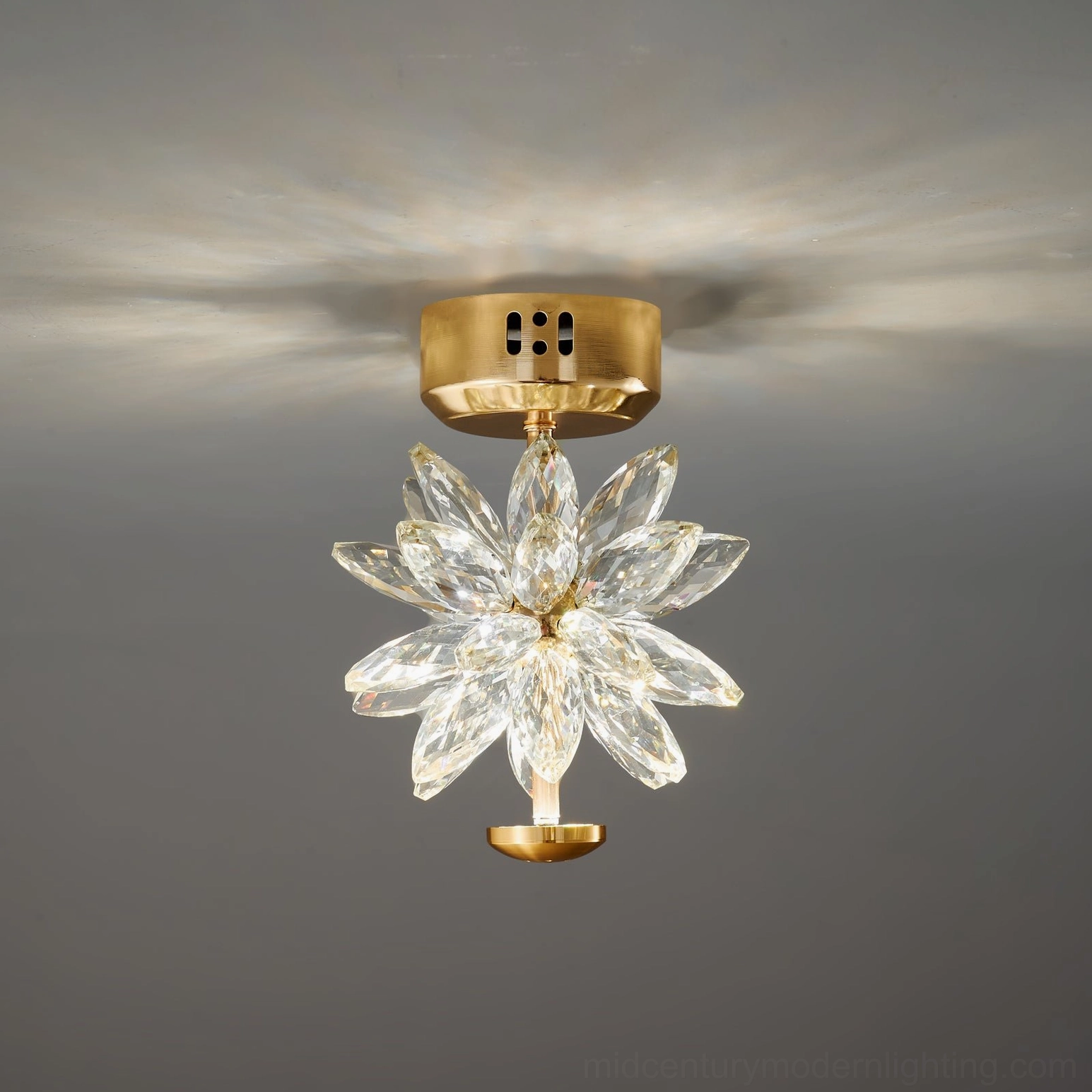 Flush mount crystal flower lamp with transparent petals, ceiling installation view showing light pattern and brass gold base