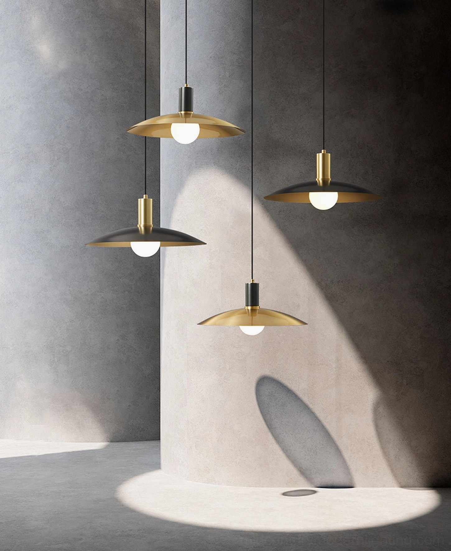 Four Aplomb pendant lights with upward low-angle view against concrete wall, dramatic natural lighting