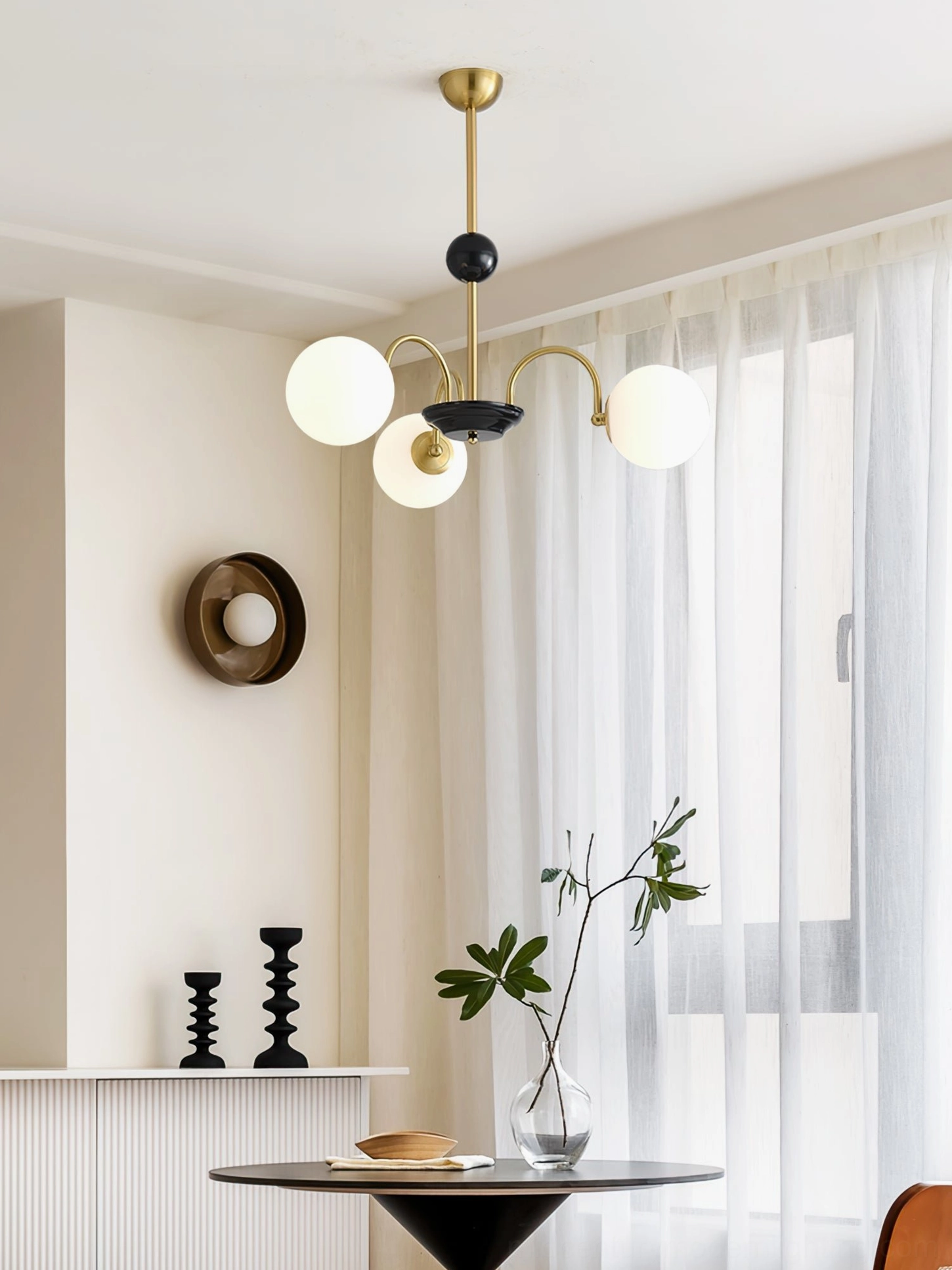 Four-head globe chandelier with gold-black frame and frosted white glass in modern dining corner