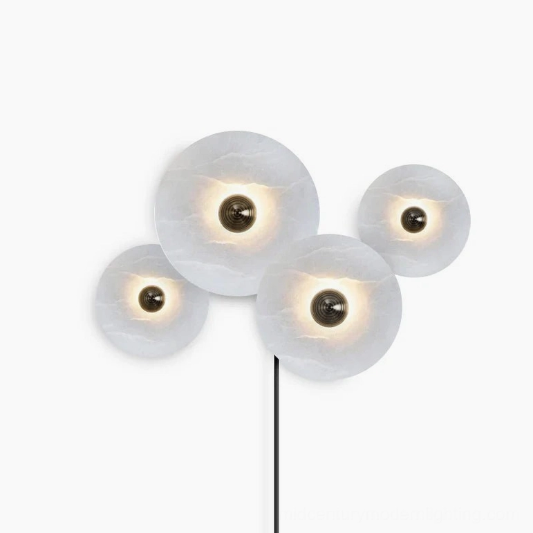 Four-lamp alabaster combination wall sconce with varied disc sizes creating dynamic sculptural composition