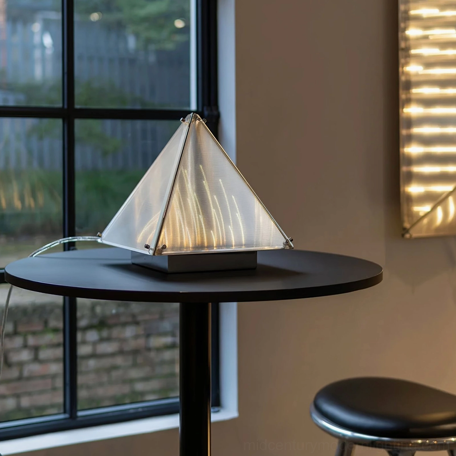 Geometric pyramid lamp base and framework showing chrome plating and structural design