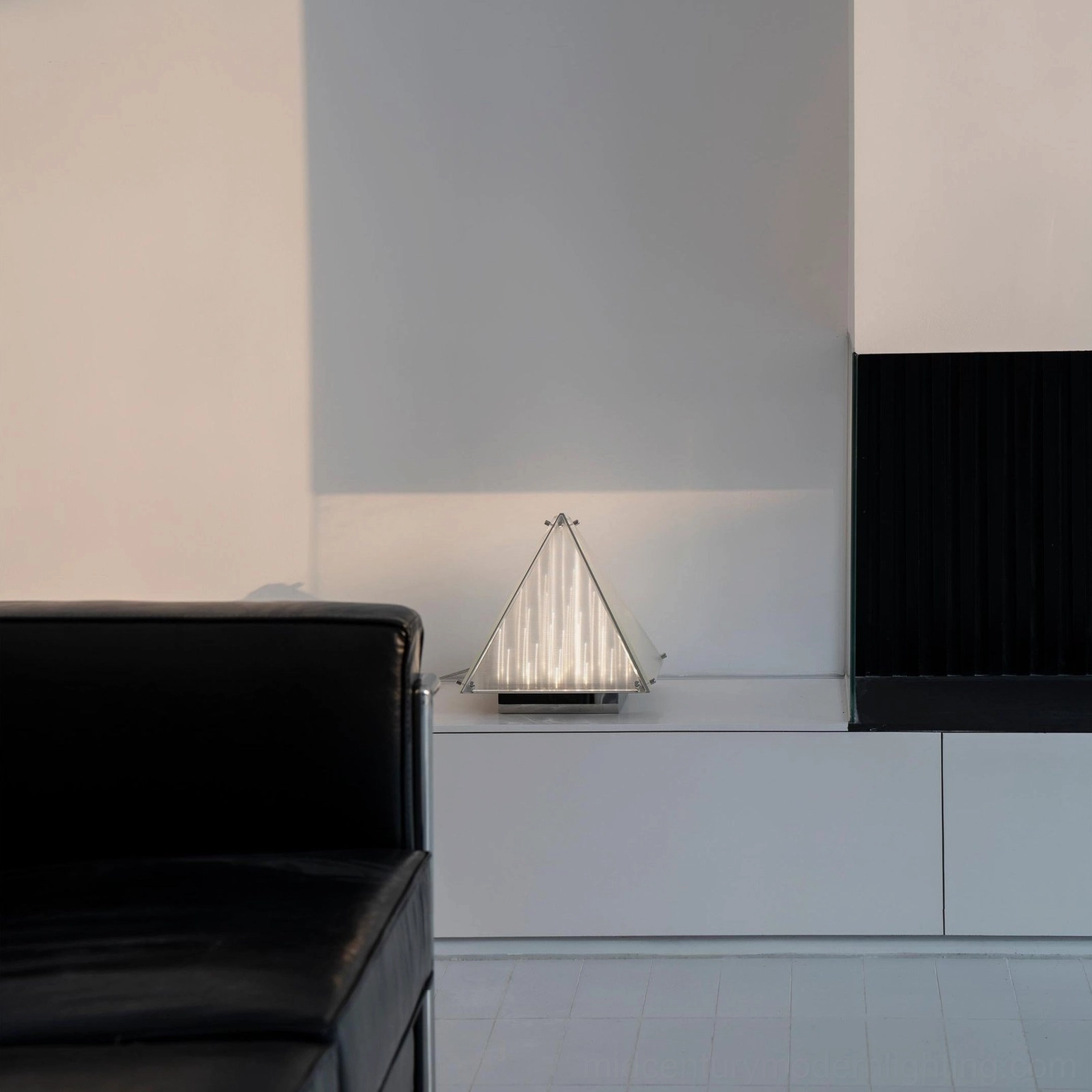 Fragment pyramid shaped lamp on nightstand as contemporary bedroom accent lighting solution