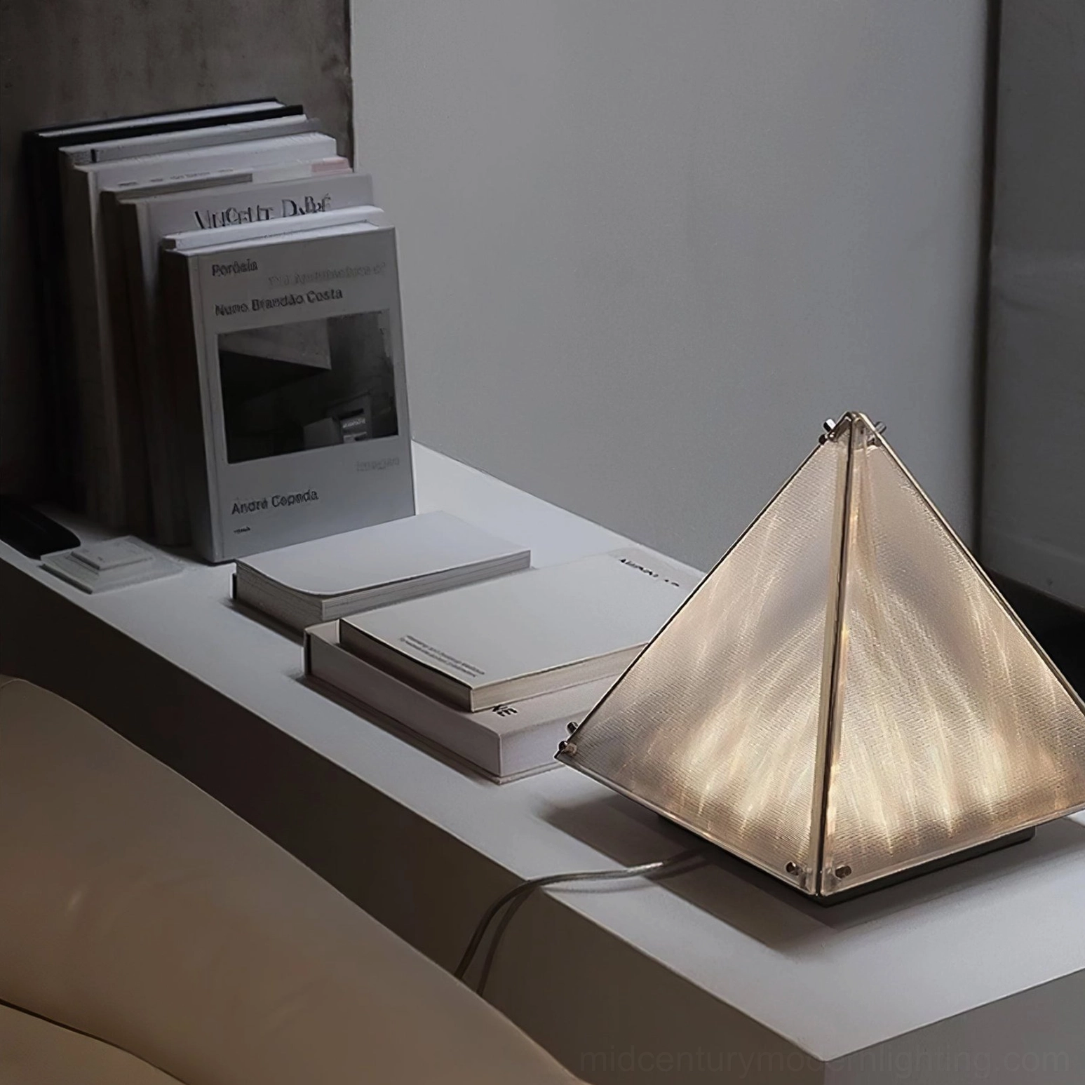 Modern pyramid shaped table lamp in luxury contemporary interior design context