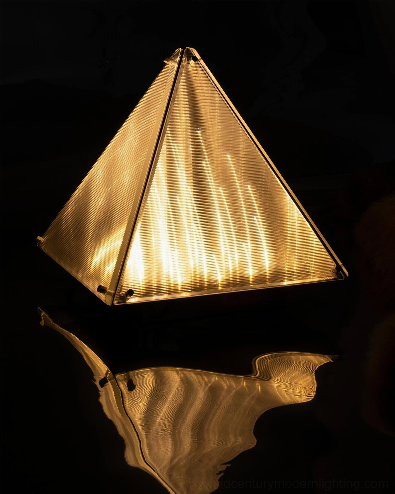 Geometric pyramid table lamp in modern home office desk lighting accent scenario
