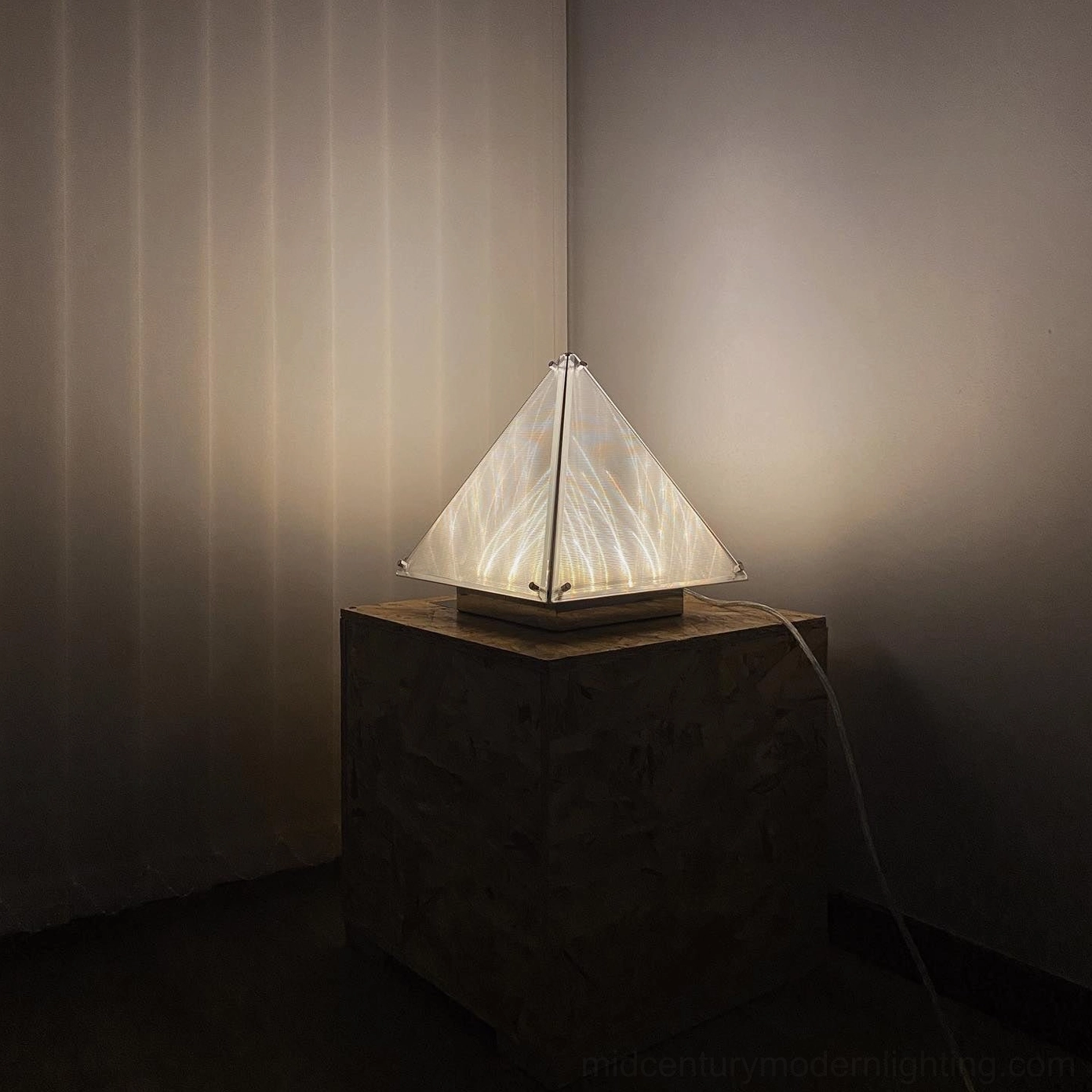 Fragment pyramid shape table lamp showcasing minimalist design aesthetic and clean lines