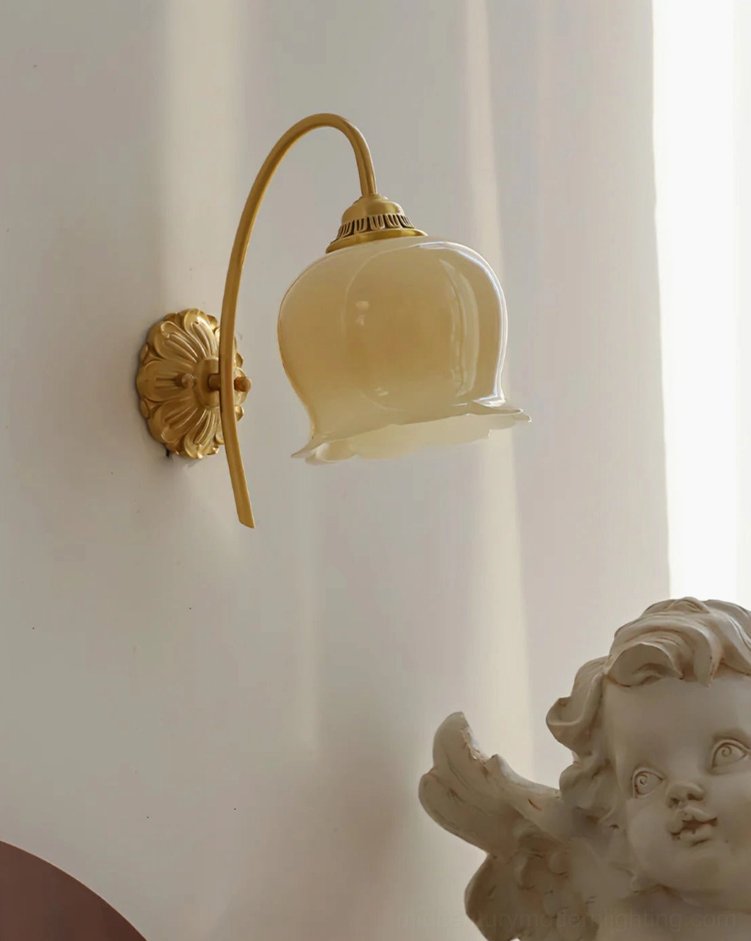 Front facing view of cream and brass lily of the valley wall sconce with elegant proportions