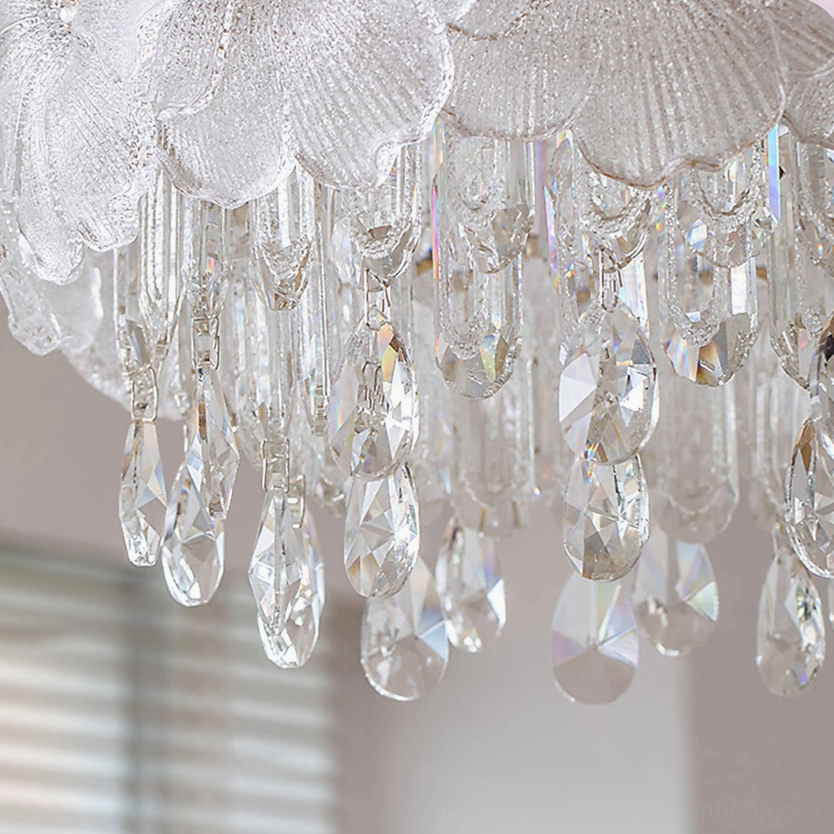 Crystal droplet pendant detail of frost flower chandelier showing faceted refraction and gold metal hardware