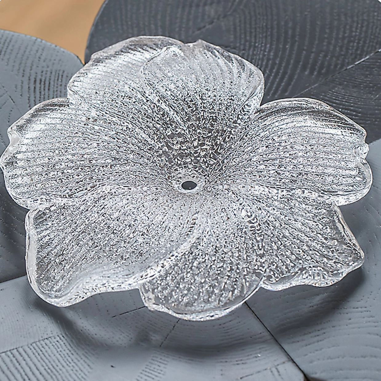 Individual frosted petal glass lampshade flat lay product photography showing textured surface design