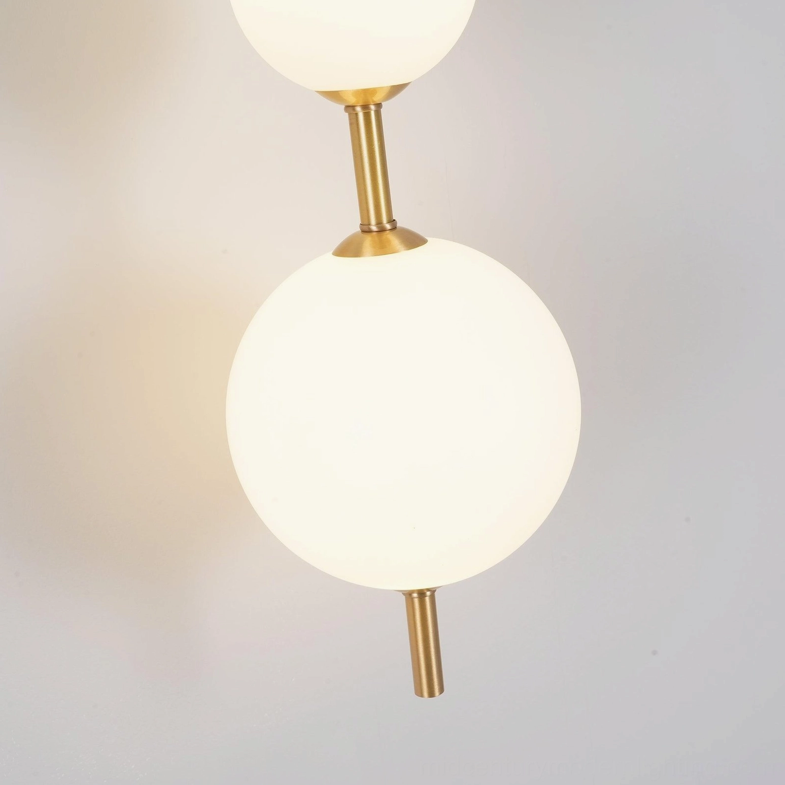 Close-up detail of frosted white glass globe shade with brass metal fittings, top-down angle