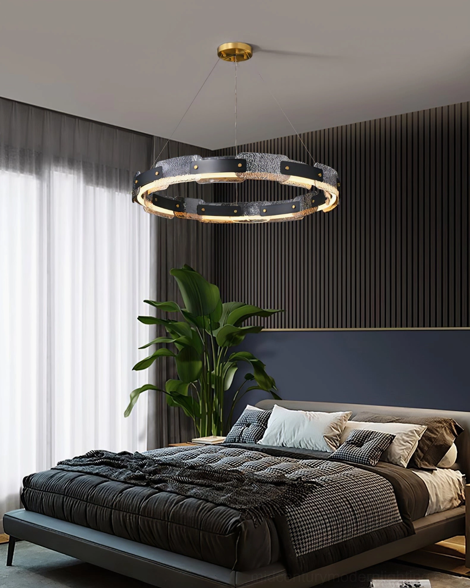 Fuze luxury pendant light in master bedroom setting with dark bedding, green floor plant and dark wood architectural trim