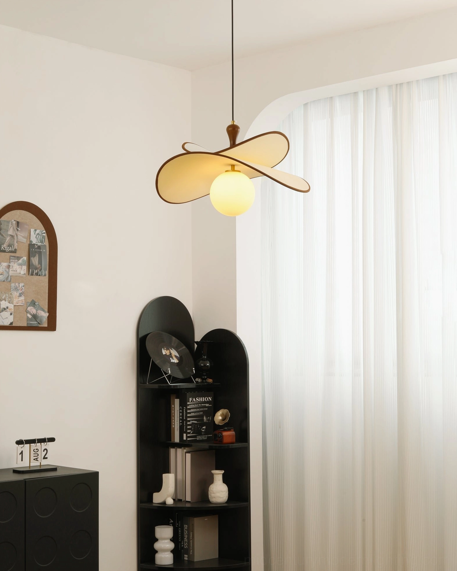 Fyano single-light sculptural pendant minimalist curved shade design indoor side perspective