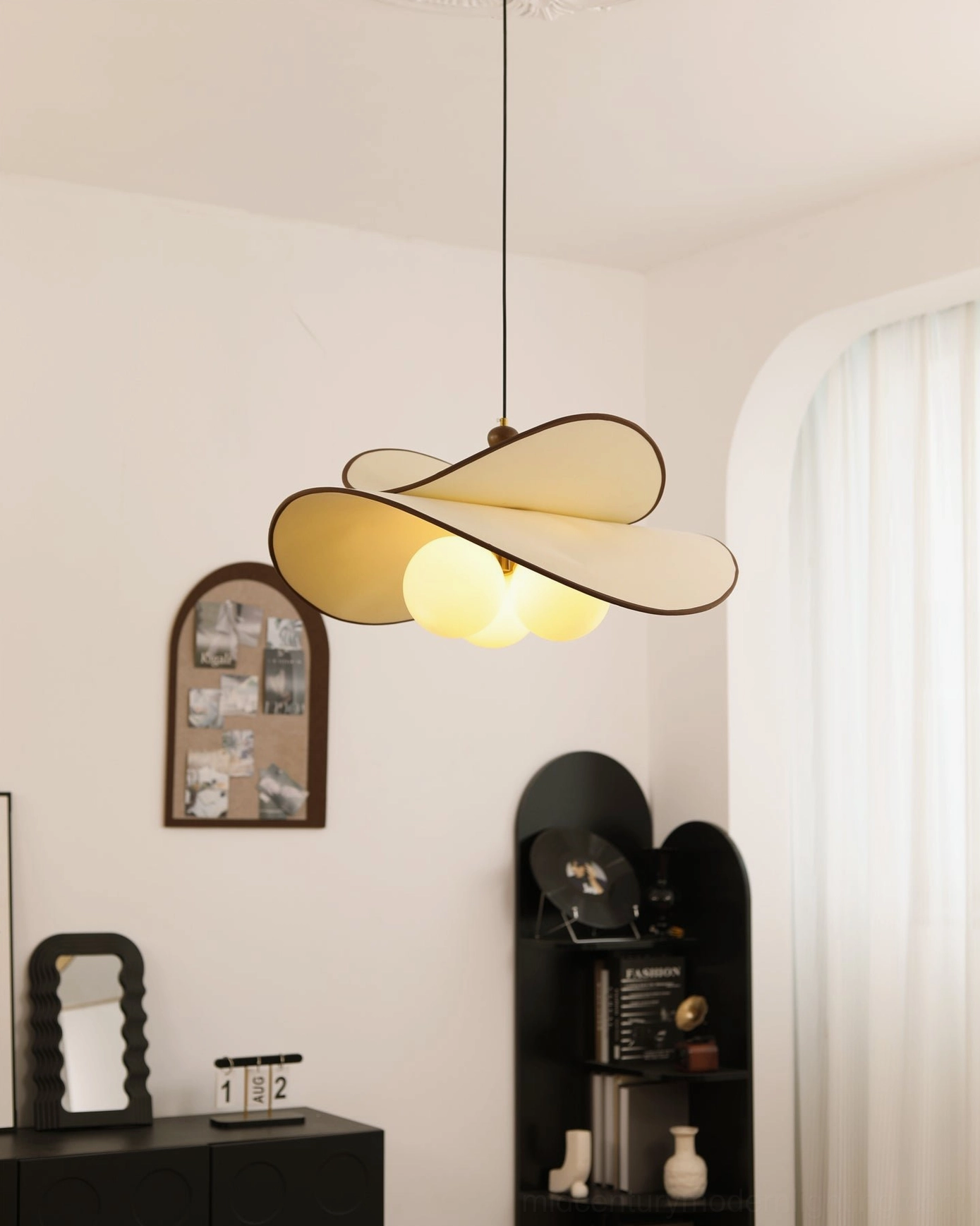 Fyano three-light pendant low-angle view dual bright warm glowing bulbs French vintage interior