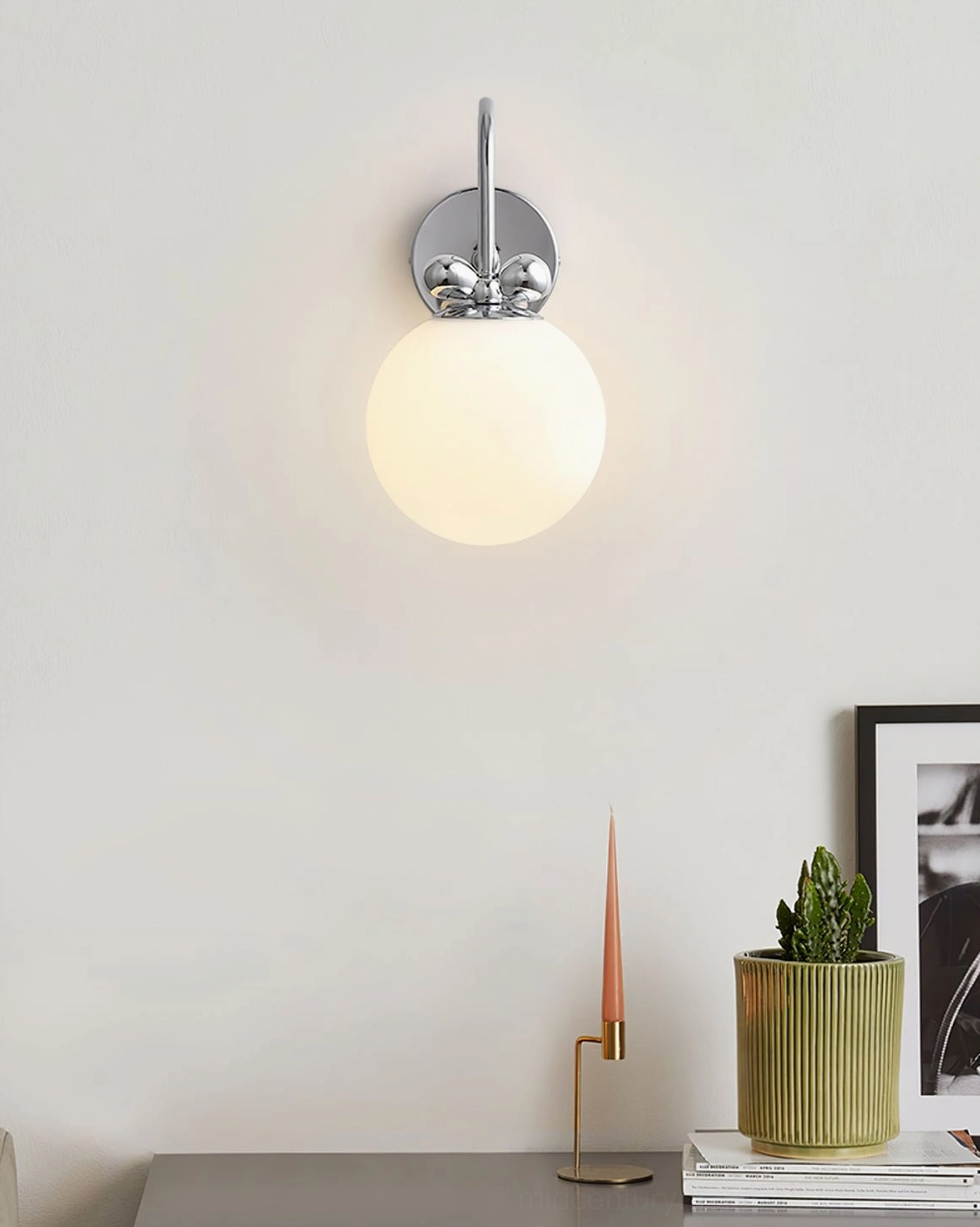 Galaxy Lux sculptural wall sconce mounted in residential setting showing S-shaped chrome arm design and frosted glass illumination