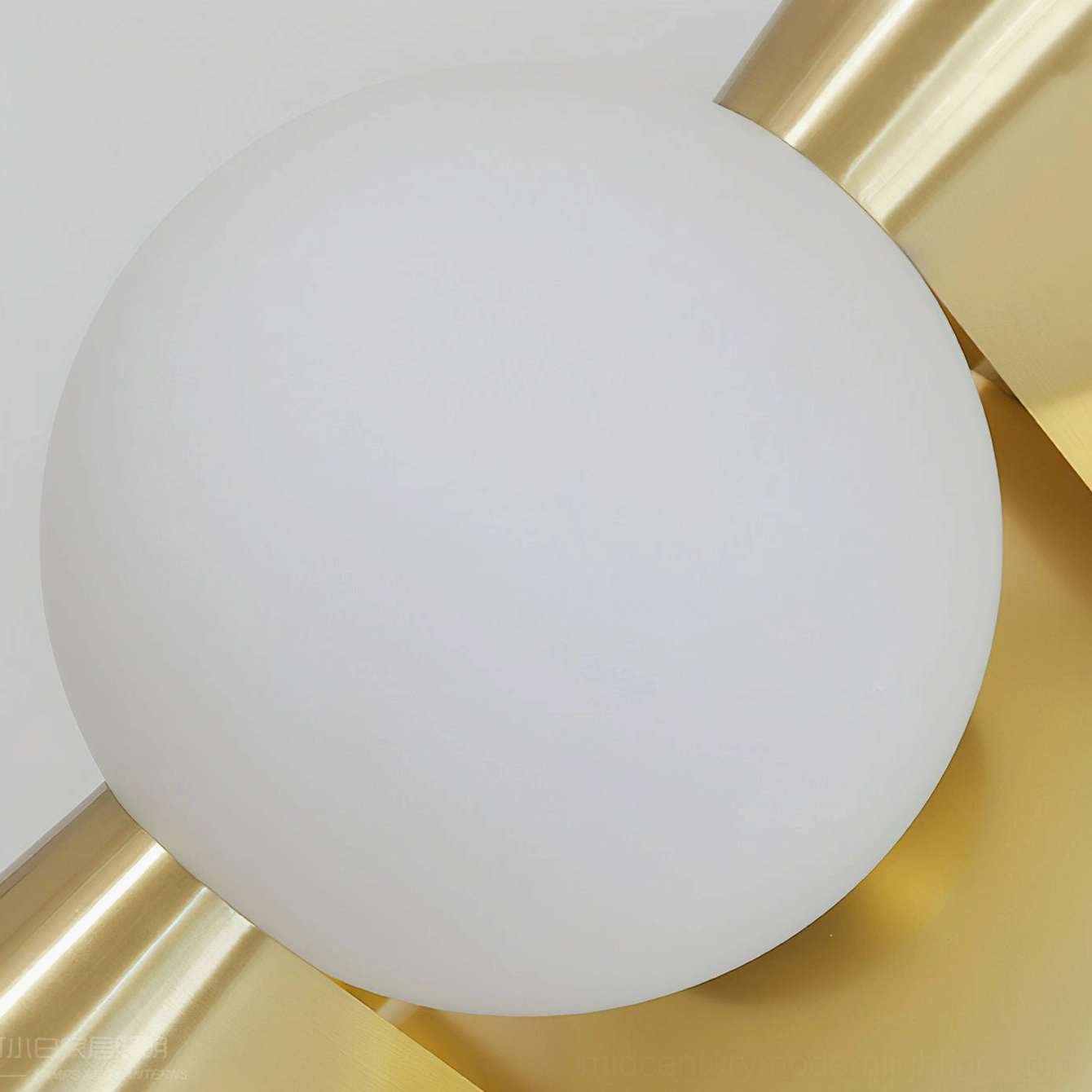 Gale Globe Wall Sconce overhead close-up of frosted white glass ball and brushed brass gold texture detail
