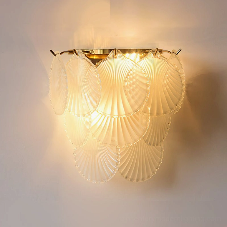 Galerie mid-century modern wall sconce with frosted glass shell, gold metalwork, and ambient lighting
