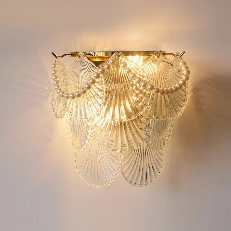 Galerie wall lamp with frosted glass shell, pearl accent trim, gold base, and warm light glow