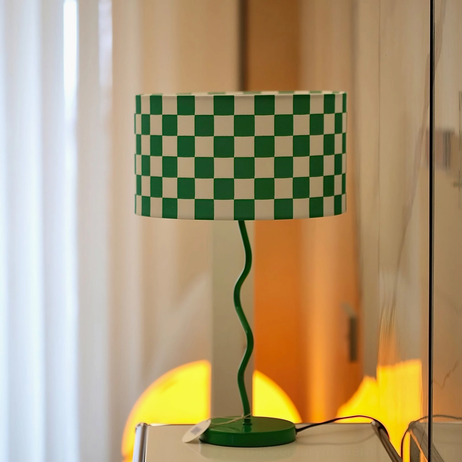 Geometric checkered table lamp positioned on windowsill casting warm ambient light indoors
