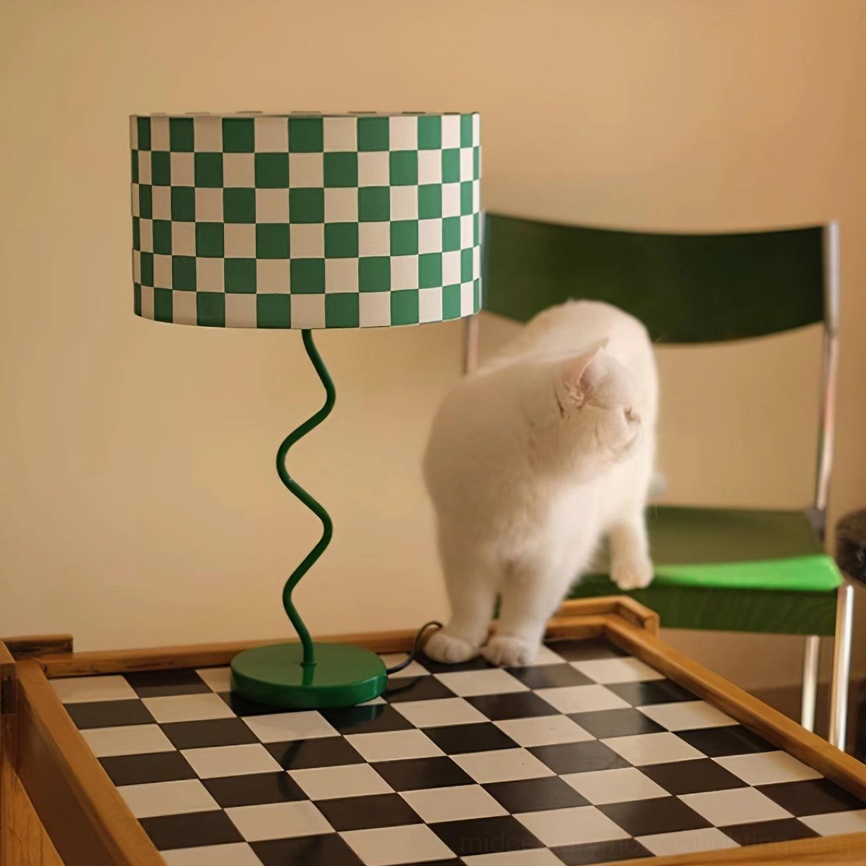Green checkered fabric lamp with white fluffy cat in minimalist home setting