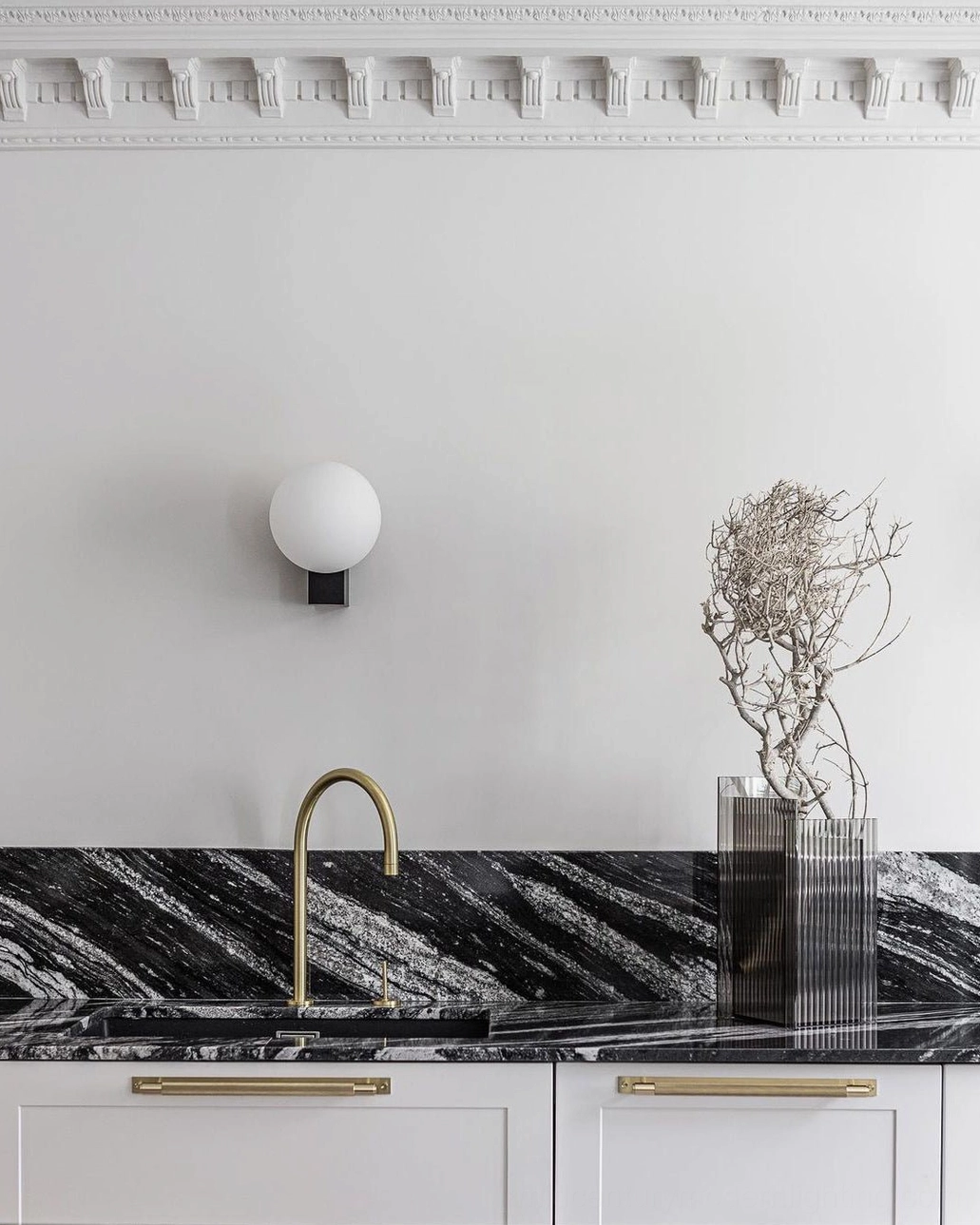 Geometric globe wall sconce showing warm light diffusion through frosted glass in contemporary interior setting