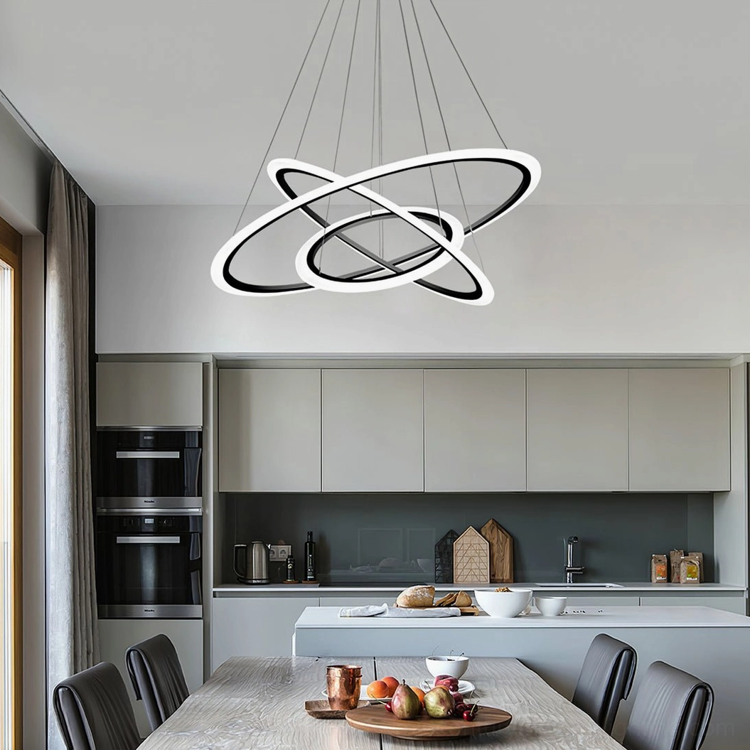 Three-interlocking circular LED chandelier in open-concept modern kitchen and dining space with warm neutral ambiance