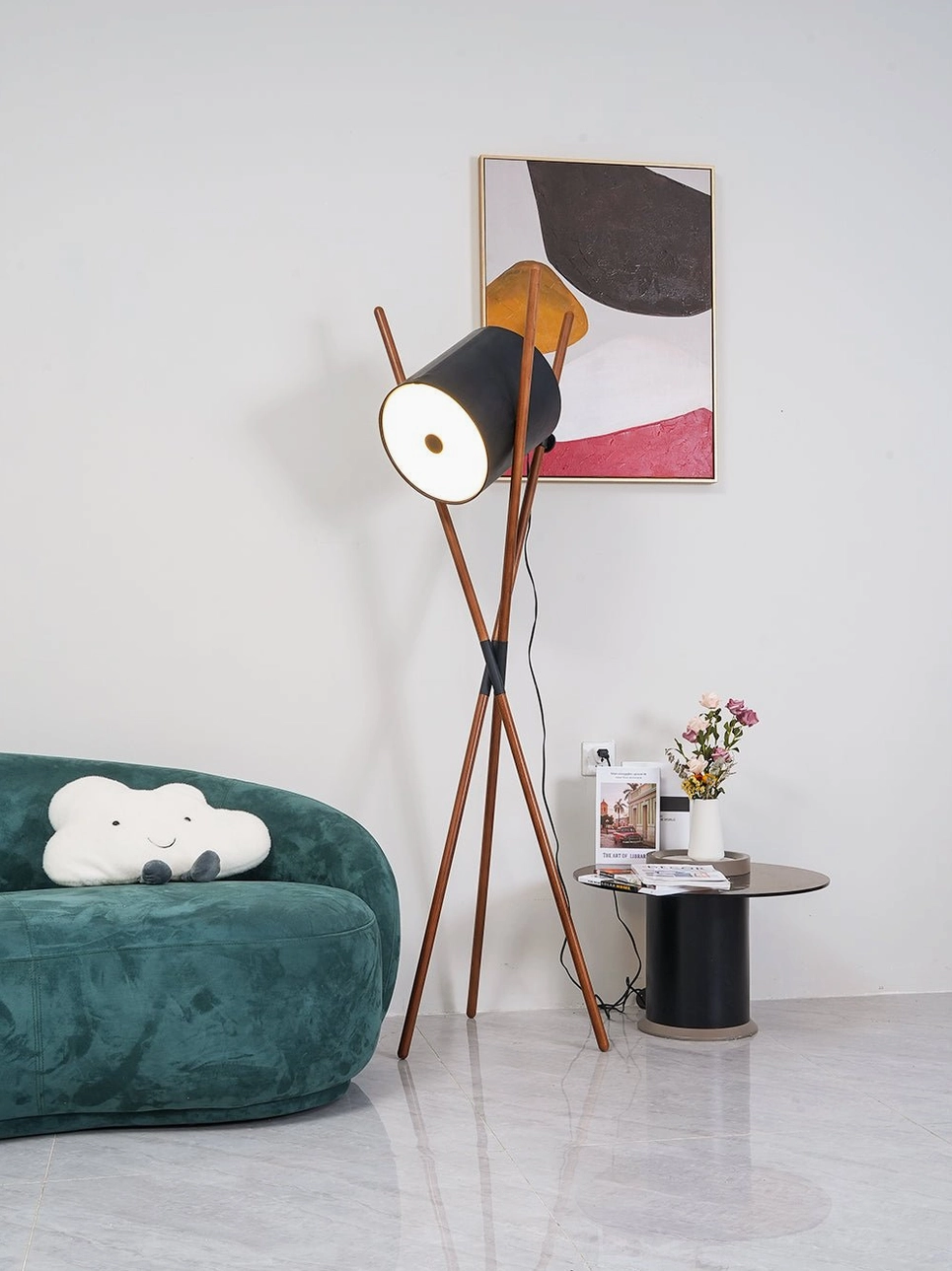 Geometric tripod floor lamp positioned beside modern sofa - mid-century design aesthetic