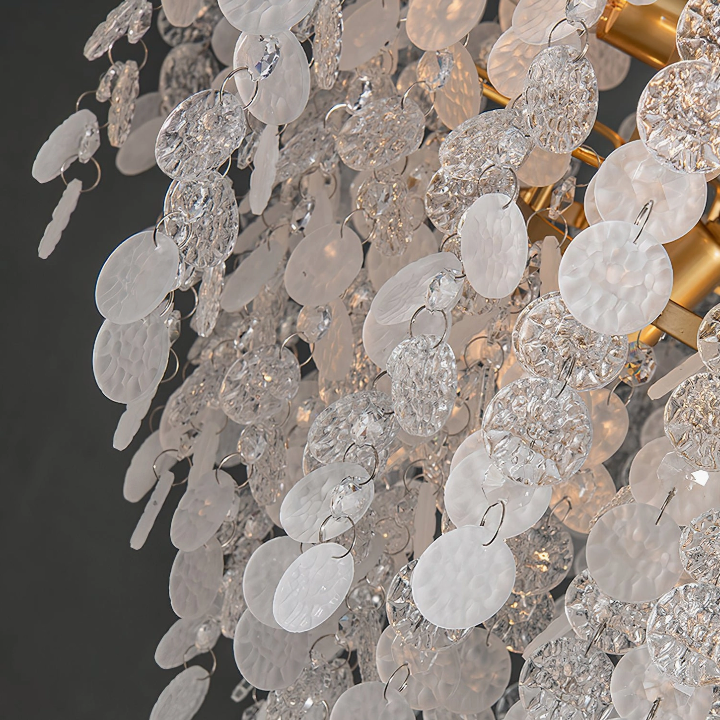 Gevan chandelier brass frame and round crystal slice pendants close-up with light shadow