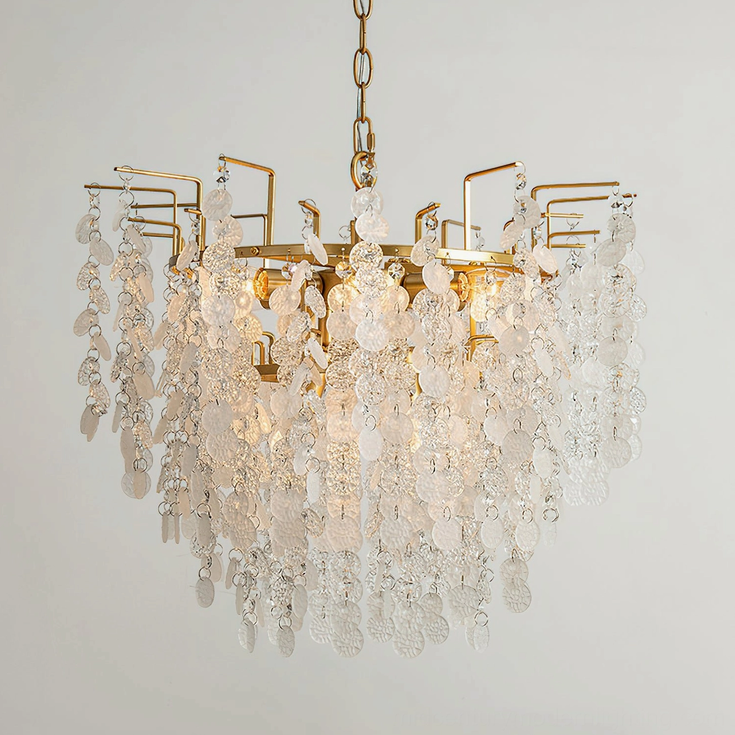 Gevan chandelier close-up side view showing brass frame and dense crystal pendant arrangement