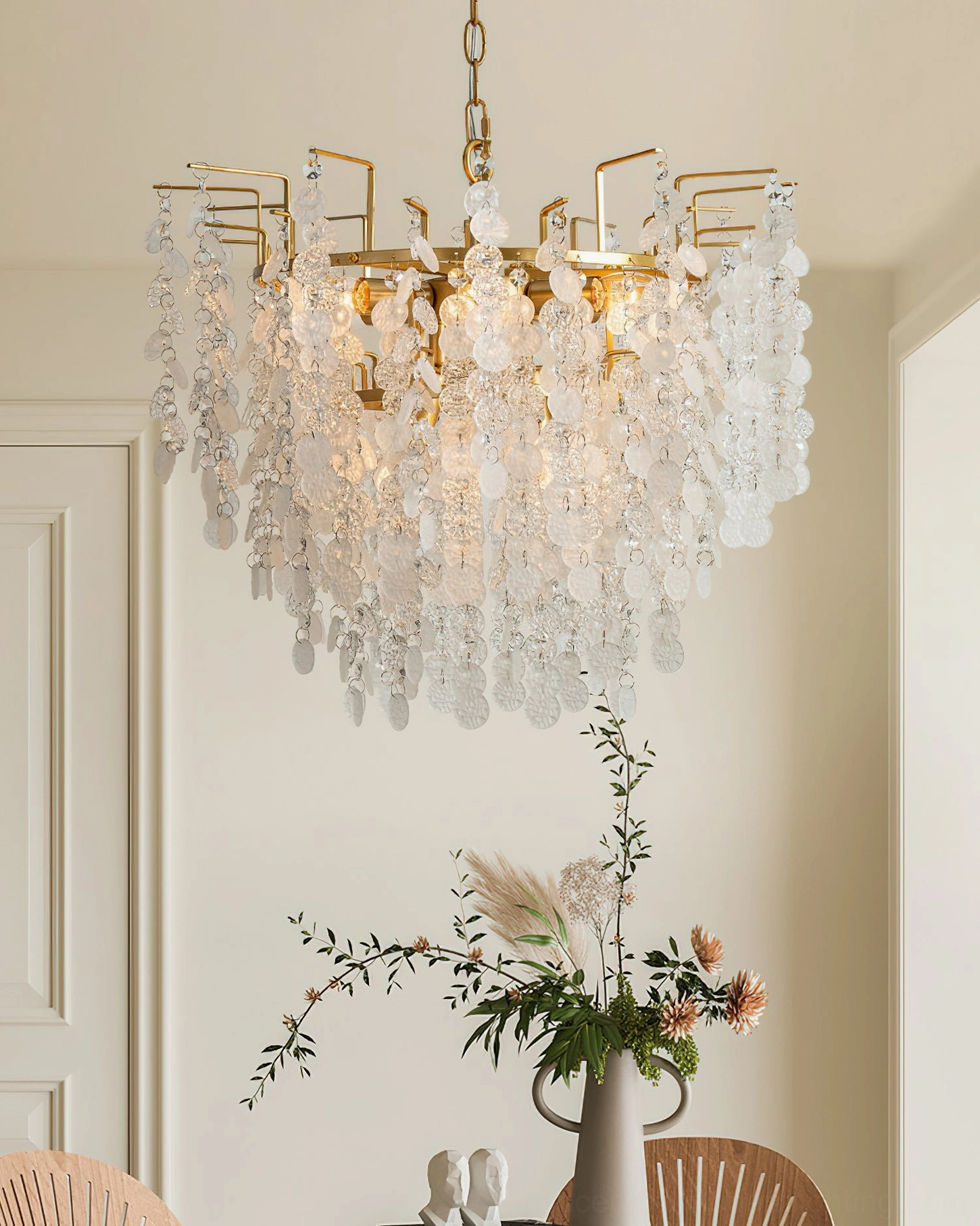 Gevan gold chandelier warm glow above dining room table with floral centerpiece