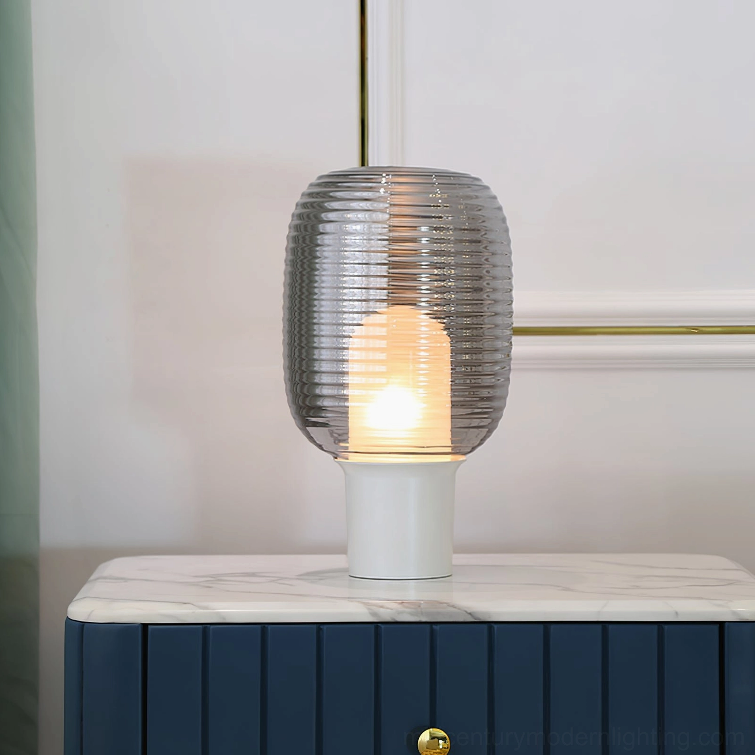 Ghia ribbed glass table lamp demonstrating warm ambient light quality in modern interior space