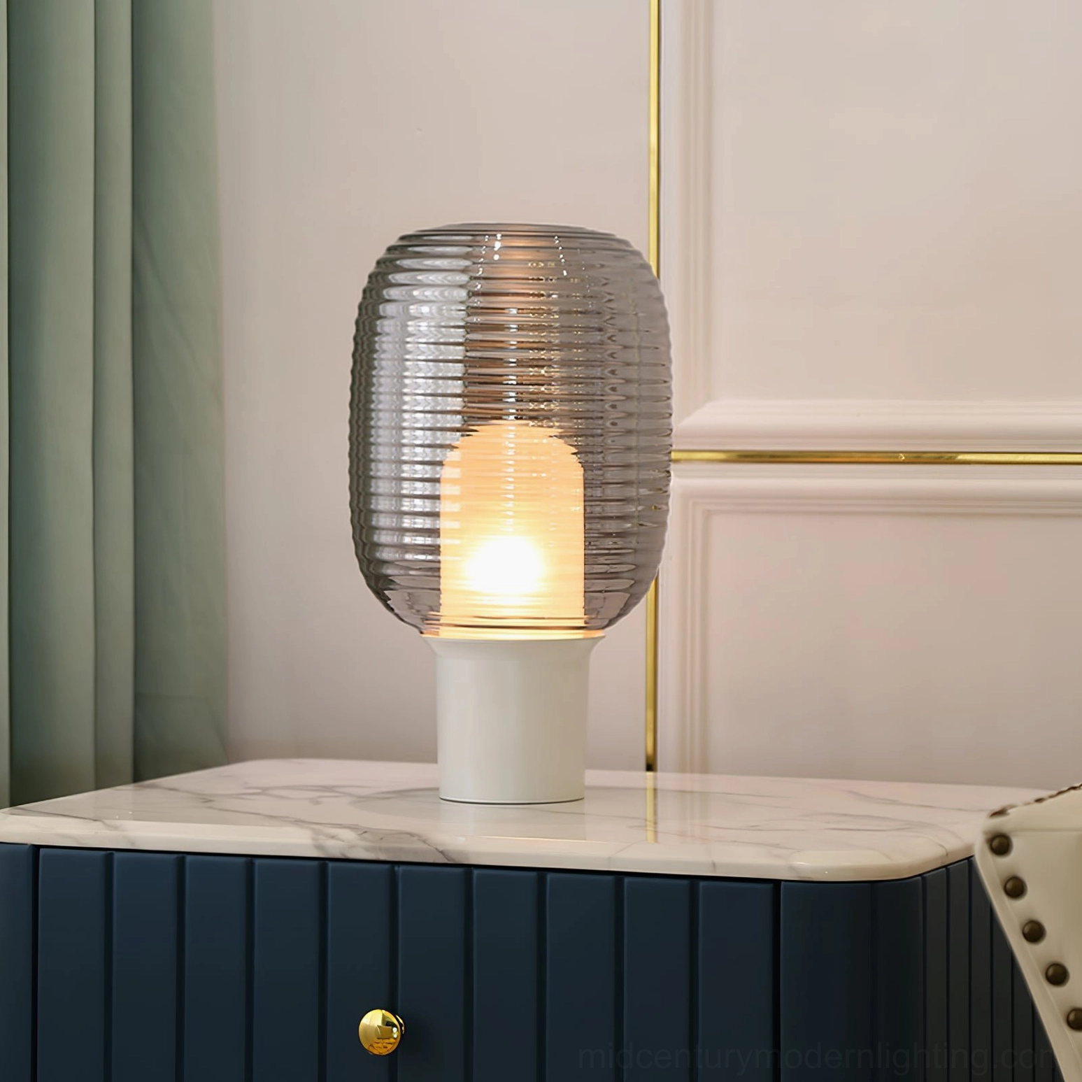 Ghia mid-century modern lamp with smoke grey shade on luxury marble bedside cabinet with gold accents