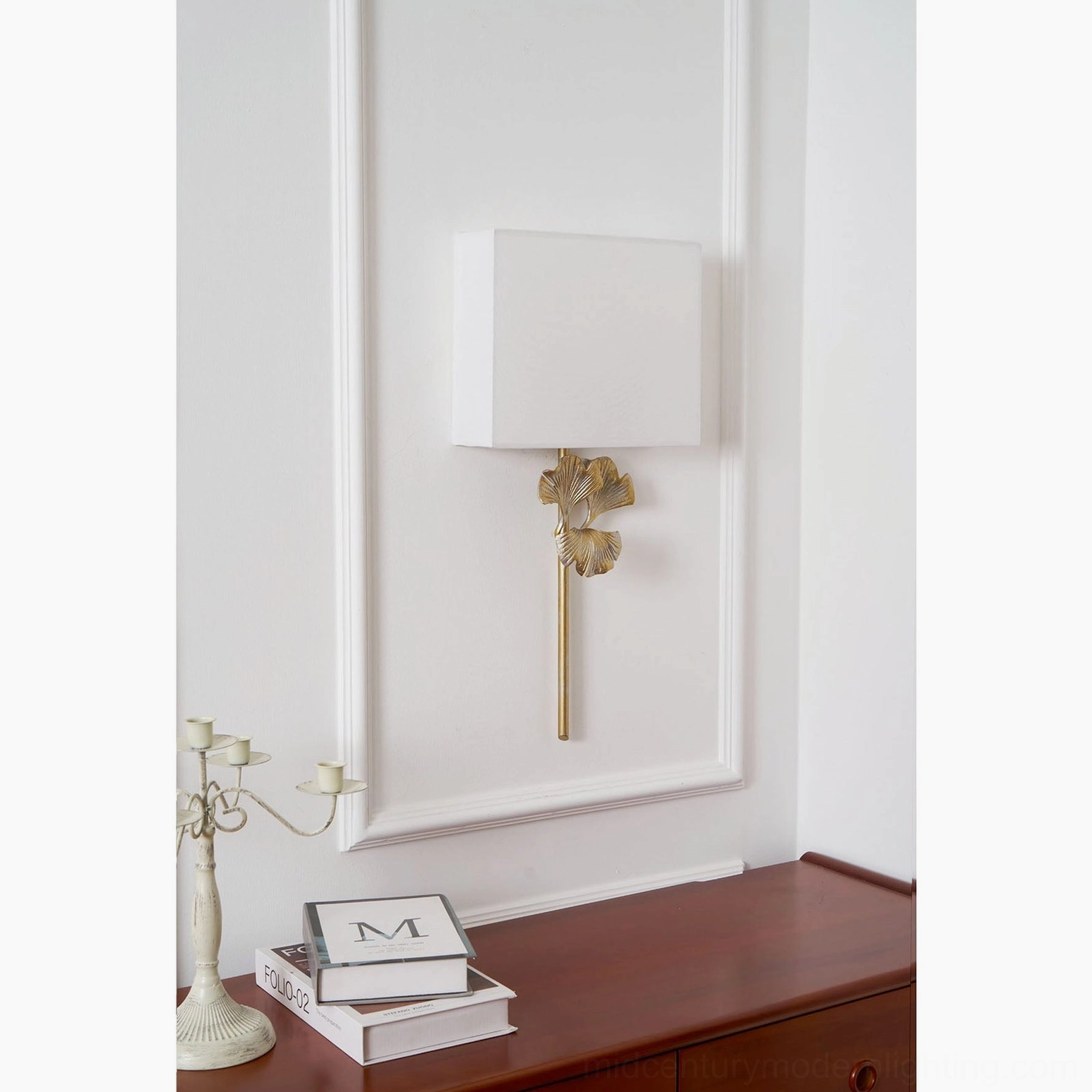 Nickel finish gingko wall sconce creating warm ambient lighting in modern bedroom