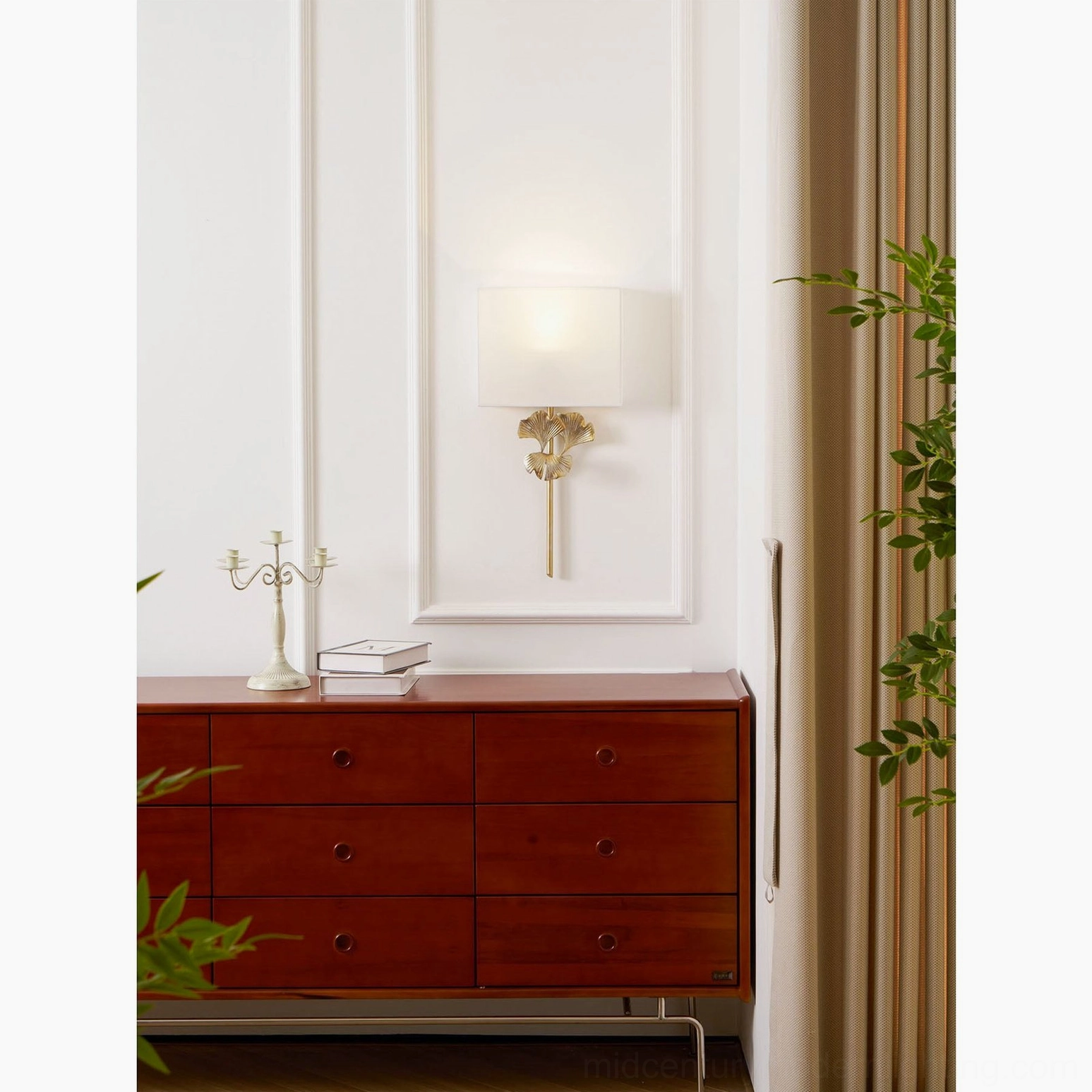 Gingko leaf wall sconce installed above mid-century modern chair with side table