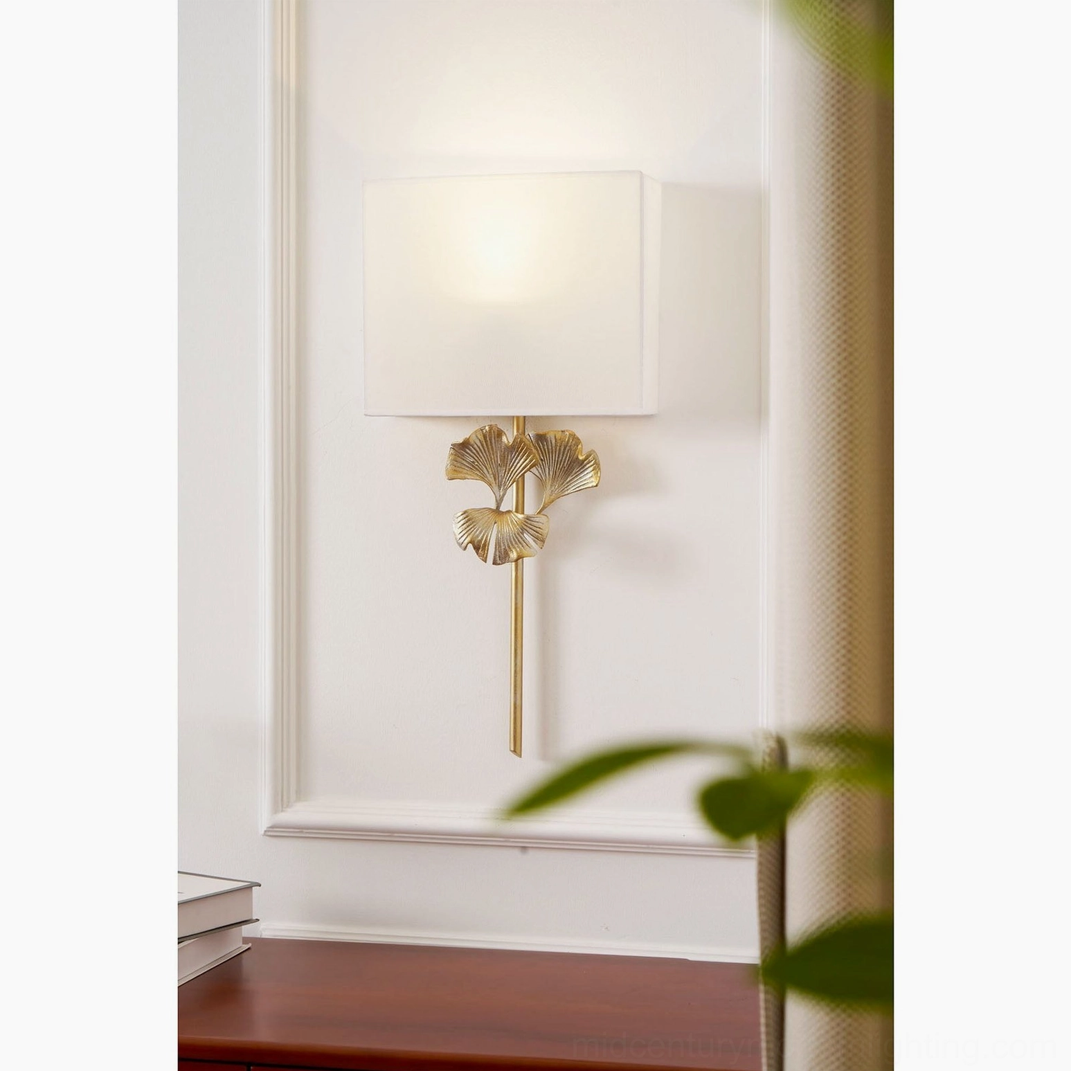 Silver old finish gingko wall lamp in contemporary living space with botanical decor
