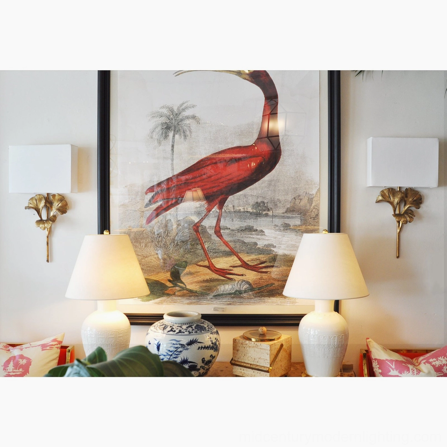 Twin gingko wall lamps flanking landscape artwork in residential living room setting