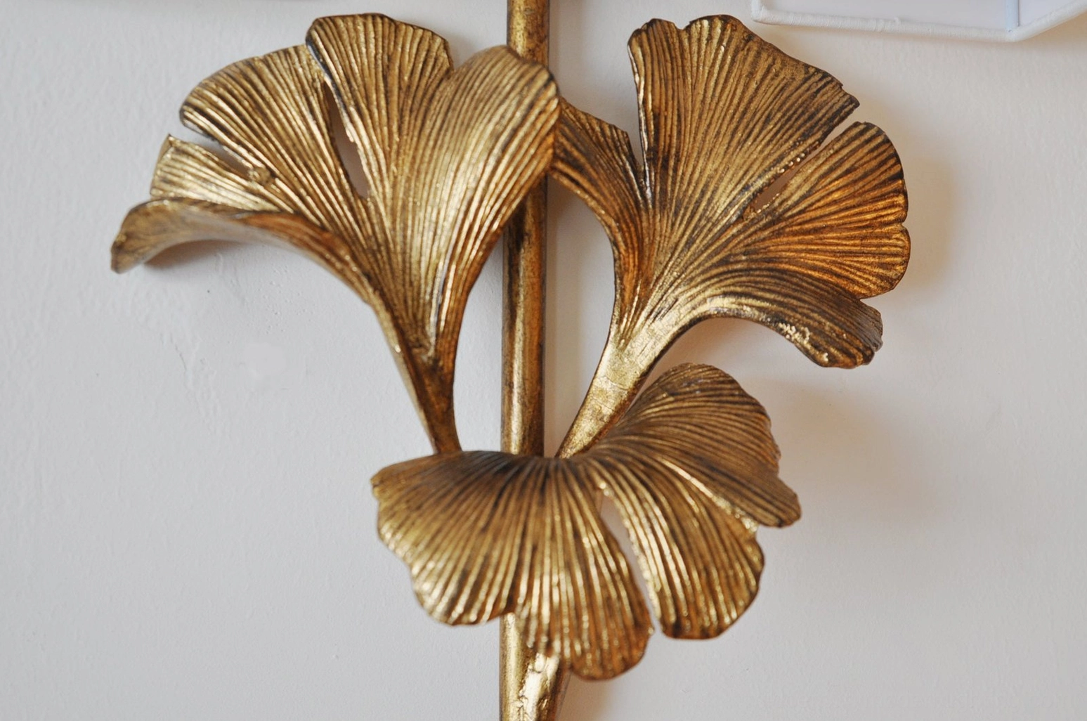 Vintage gingko leaf wall lamp showing brass patina and fabric shade construction