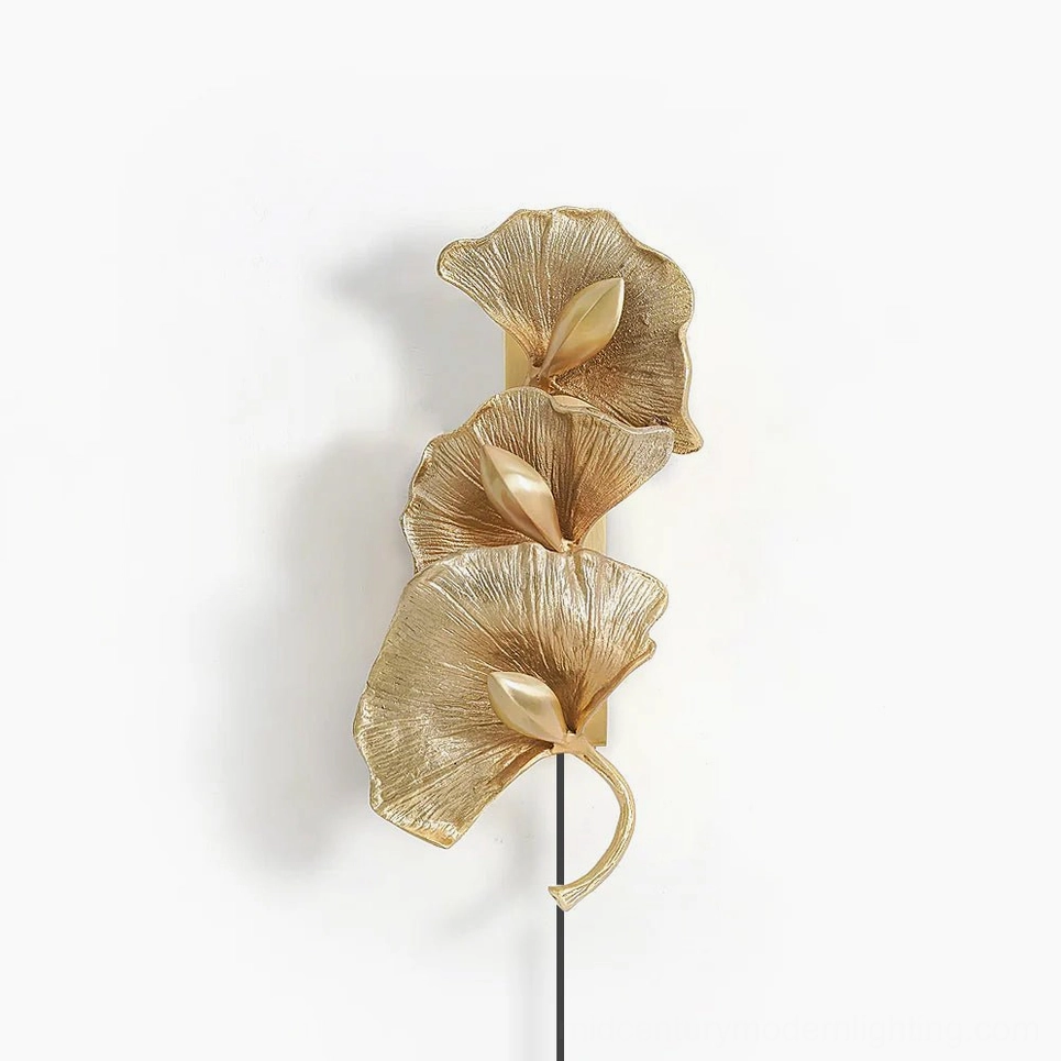 Ginkgo leaf brass wall lamp with sculptural fan-shaped design in golden finish, front studio view